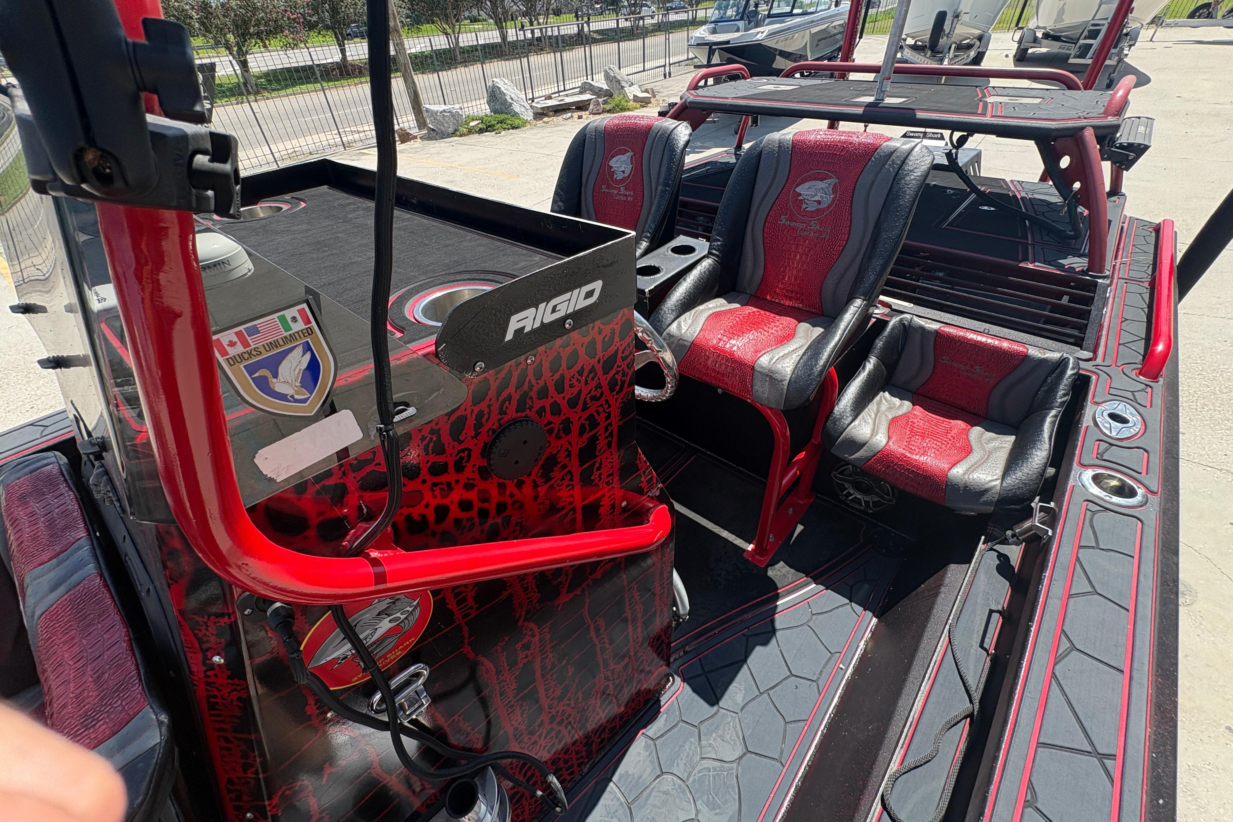 Custom 2018 Swamp Shark 24' boat interior with red and black seating and Rigid branding.