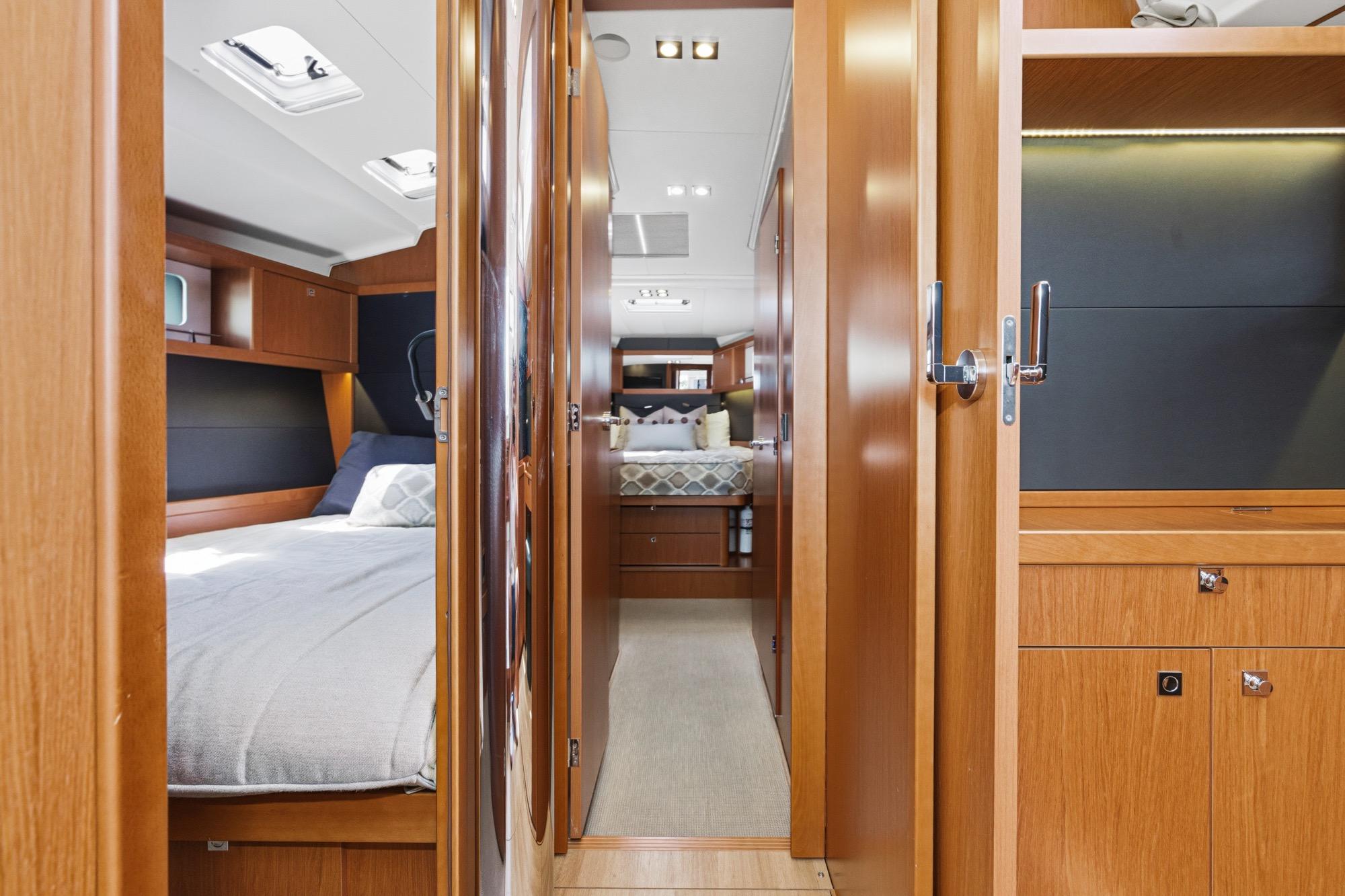 Luxurious interior of 2017 Beneteau Sense 50 yacht, featuring elegant wood finishes and cozy sleeping quarters.