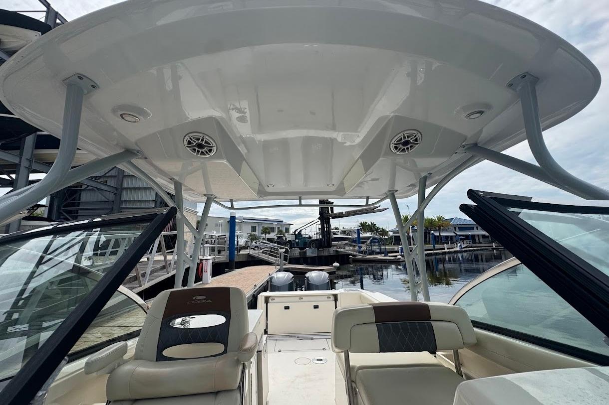 2020 Cobia 280 Dual Console boat interior with seating and open deck at marina.