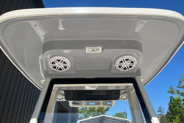 2026 Key West 239 FS boat T-top with speakers and light, under clear blue sky.