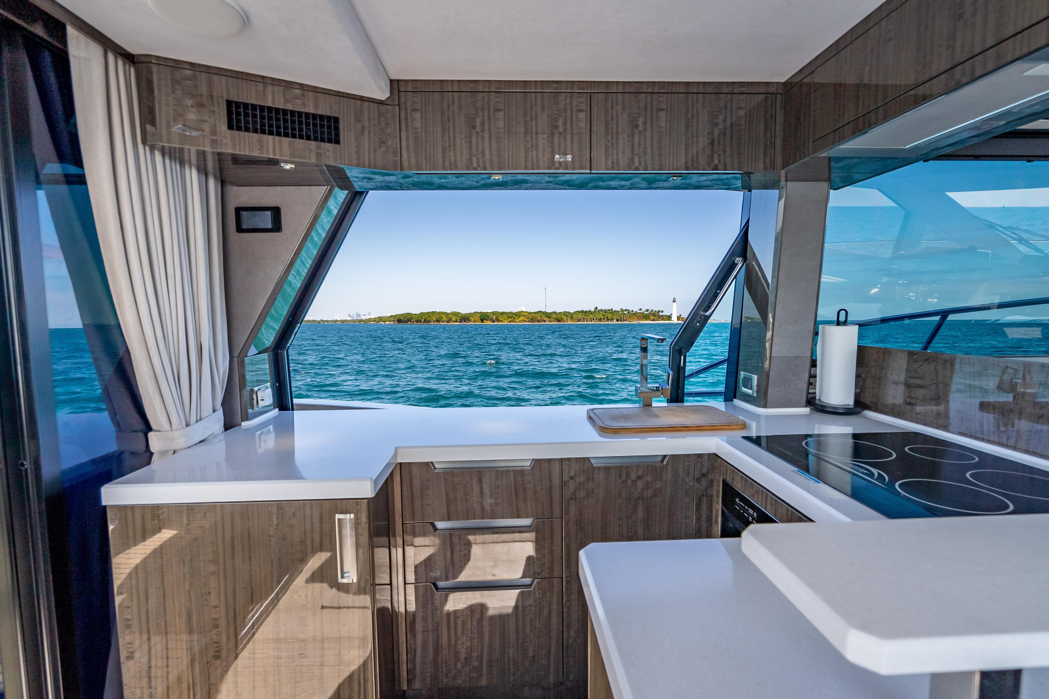 Modern kitchen interior on 2021 Galeon 500 Fly yacht with ocean view.