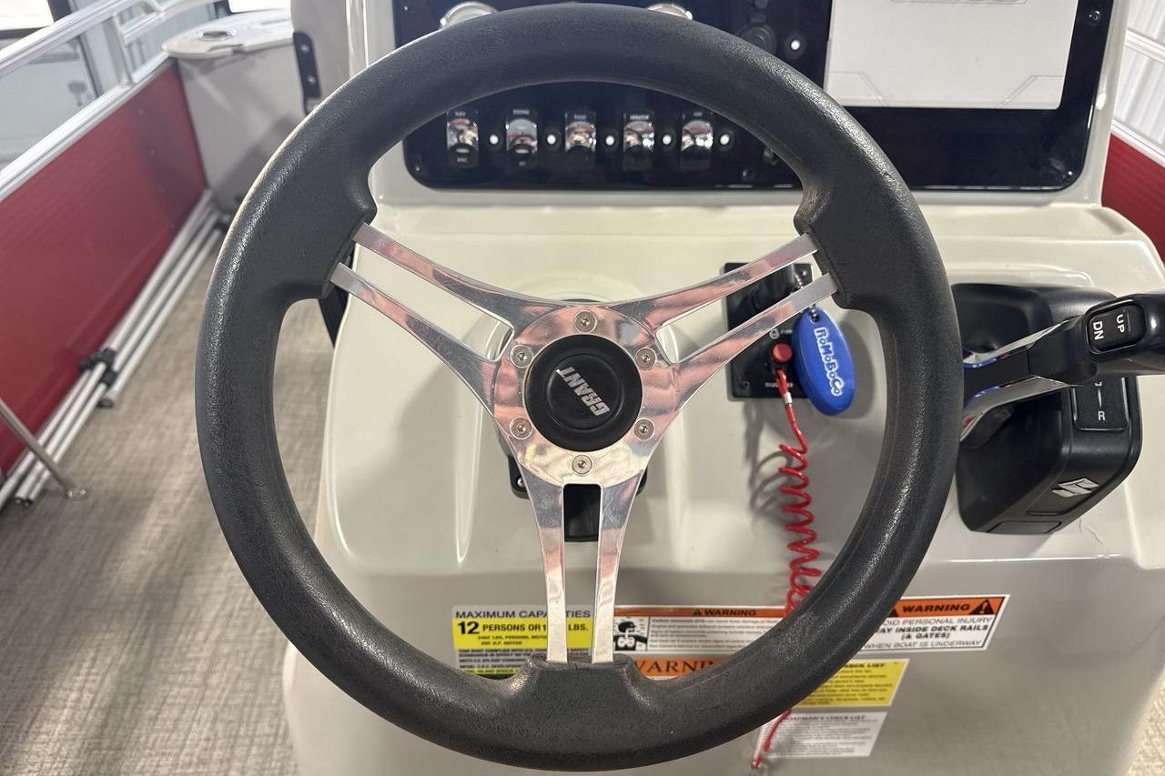 Steering wheel of 2022 Landau ALURE 232 boat with control panel and throttle.