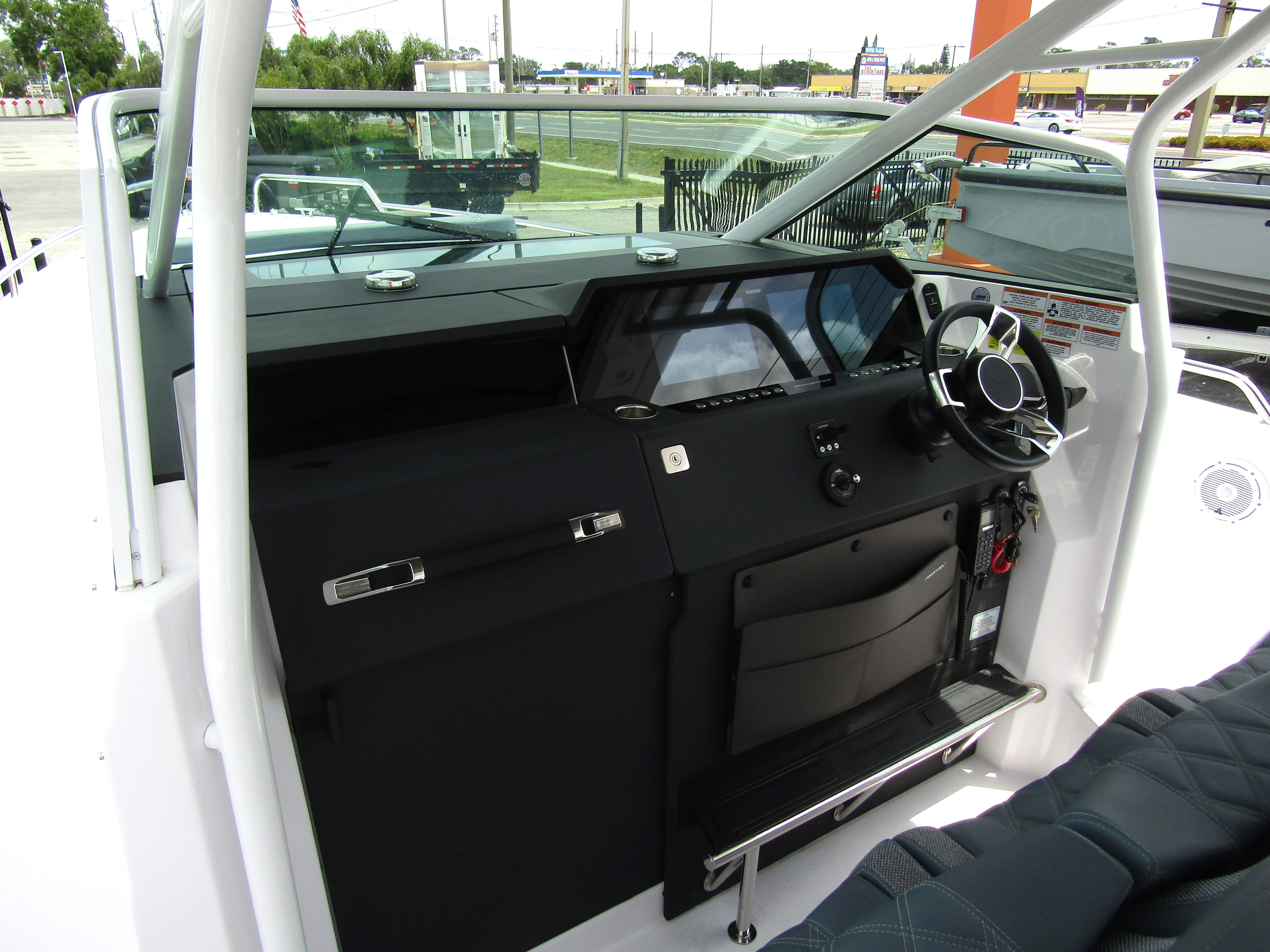 2024 Axopar 37 Sun Top boat cockpit with modern steering and dashboard controls.