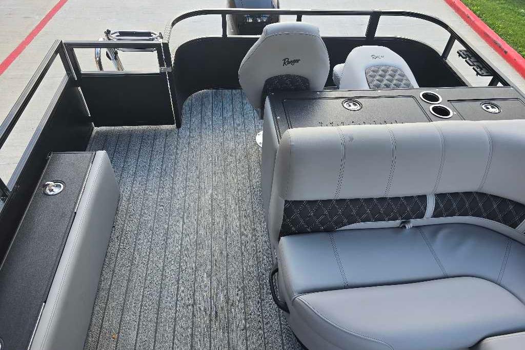 2026 Ranger 223FC boat interior with gray seating and carpeted flooring.