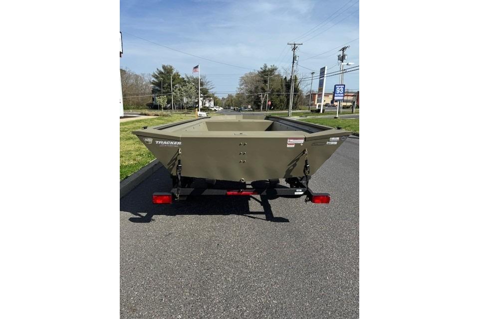 2026 Tracker Grizzly 1860 Utility boat on trailer, parked on a suburban street.
