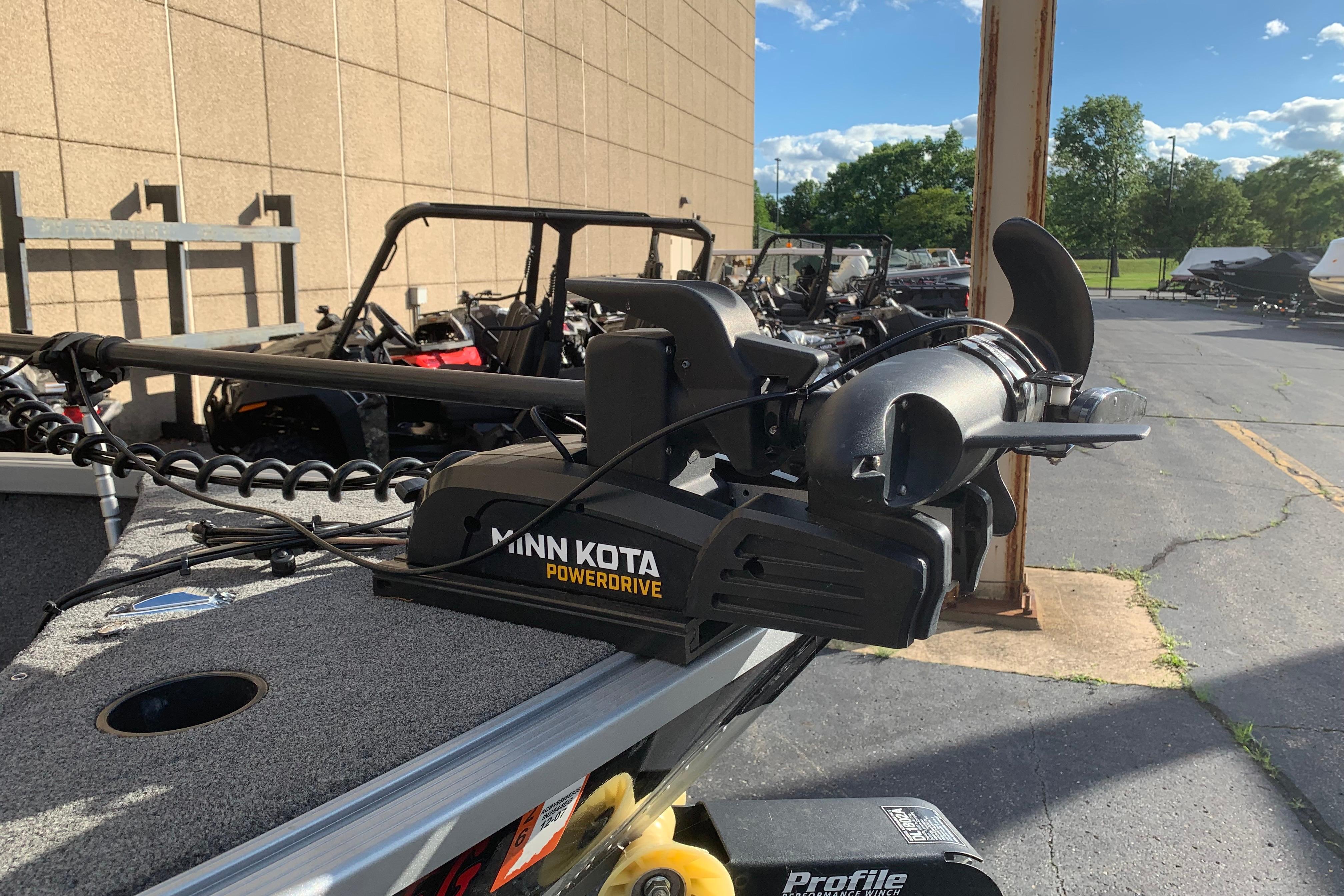 Minn Kota PowerDrive trolling motor on 1993 Alumacraft Trophy 175 boat, parked outdoors.