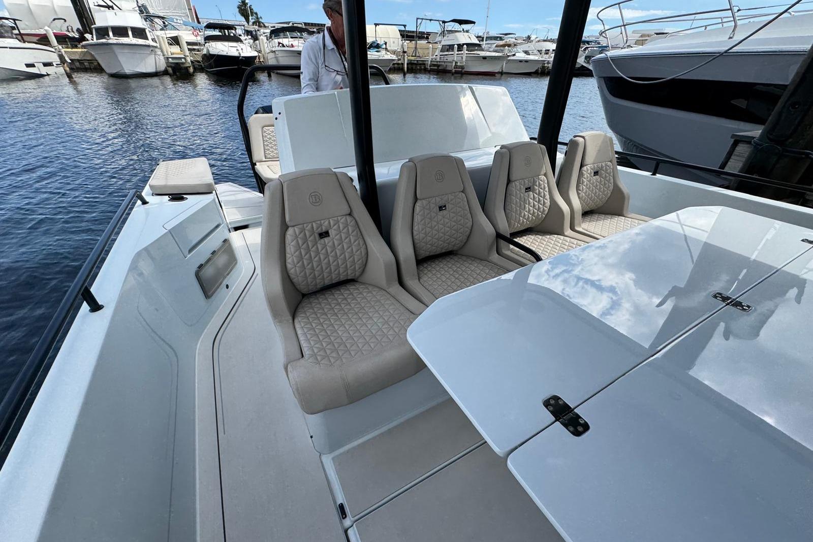 2023 BRABUS Shadow 900 ST luxury boat interior with plush seating at marina.