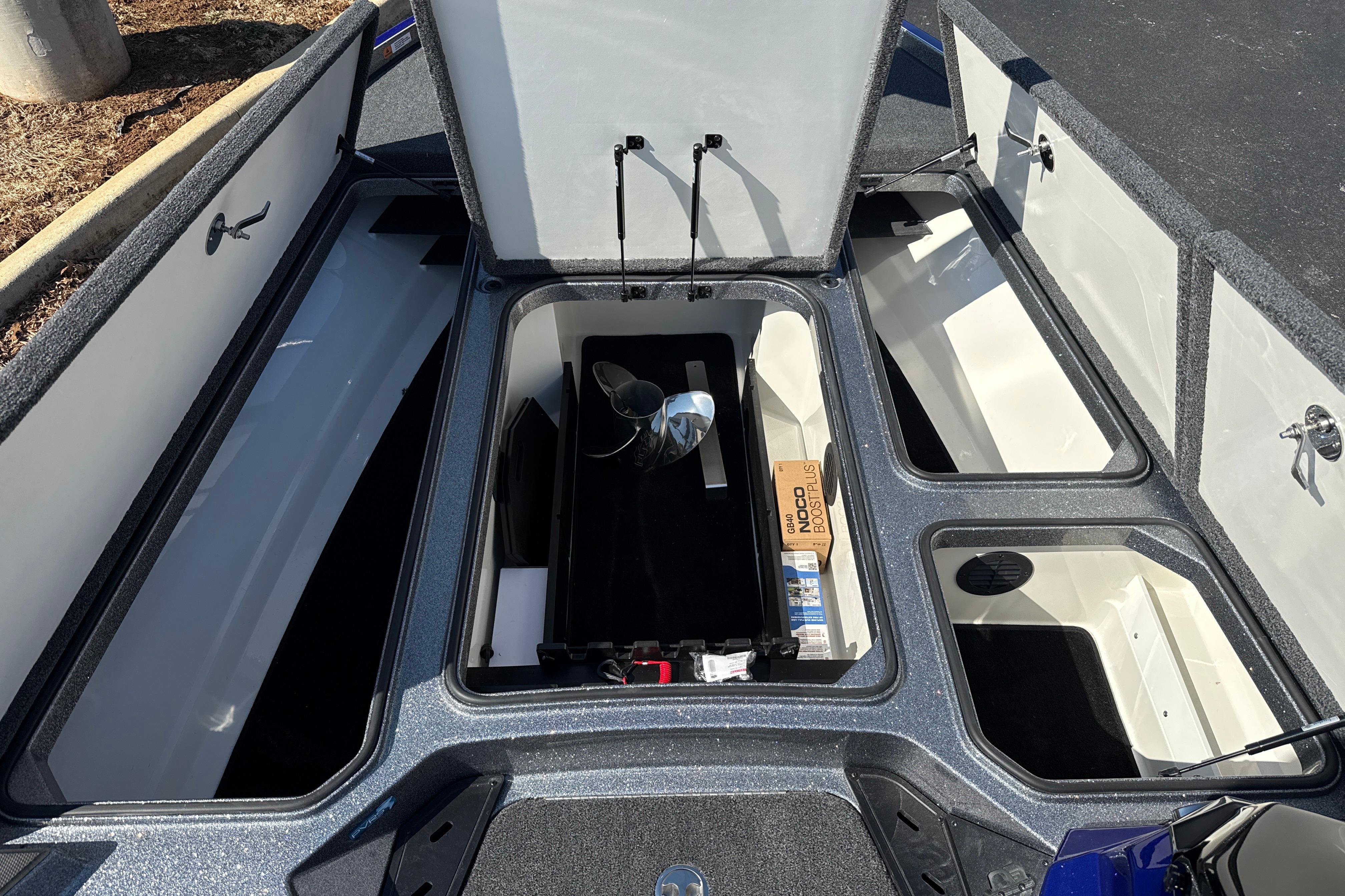 2026 Ranger Z521 boat storage compartments with open lids, showcasing spacious interior design.