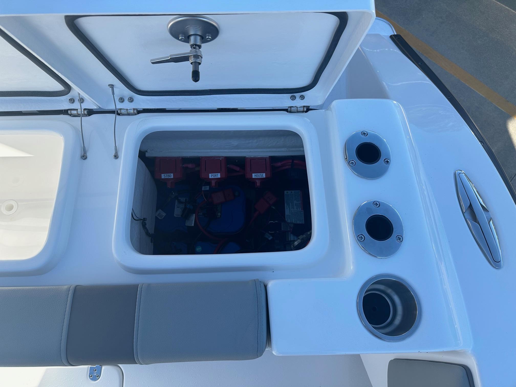 2025 Cape Horn 28XS boat storage compartment with open hatch and cup holders.