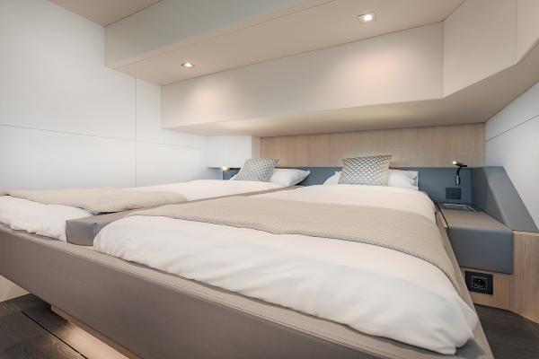 Luxurious bedroom interior of 2025 Privilege Signature 650 yacht with modern design.