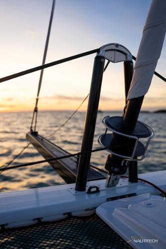 2025 Nautitech 48 Open sailing at sunset, showcasing sleek design and advanced rigging.