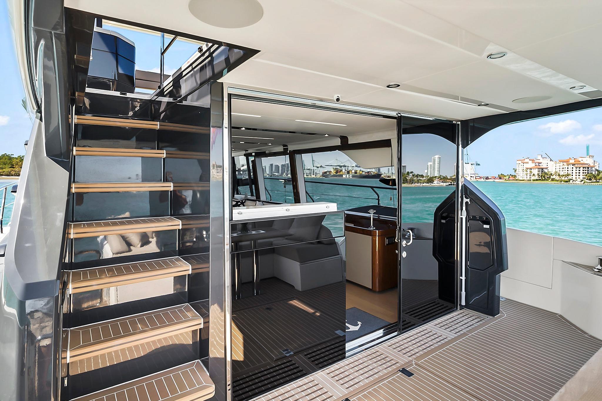 Luxury 2021 Fairline Squadron 68 yacht interior with staircase and ocean view.