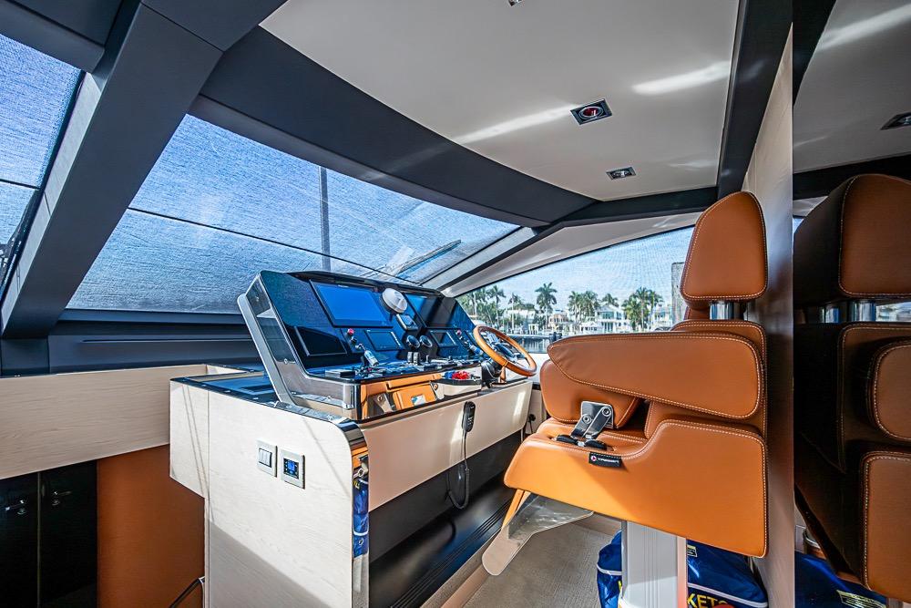 Luxurious helm of 2017 Azimut 80 yacht with leather seating and modern controls.