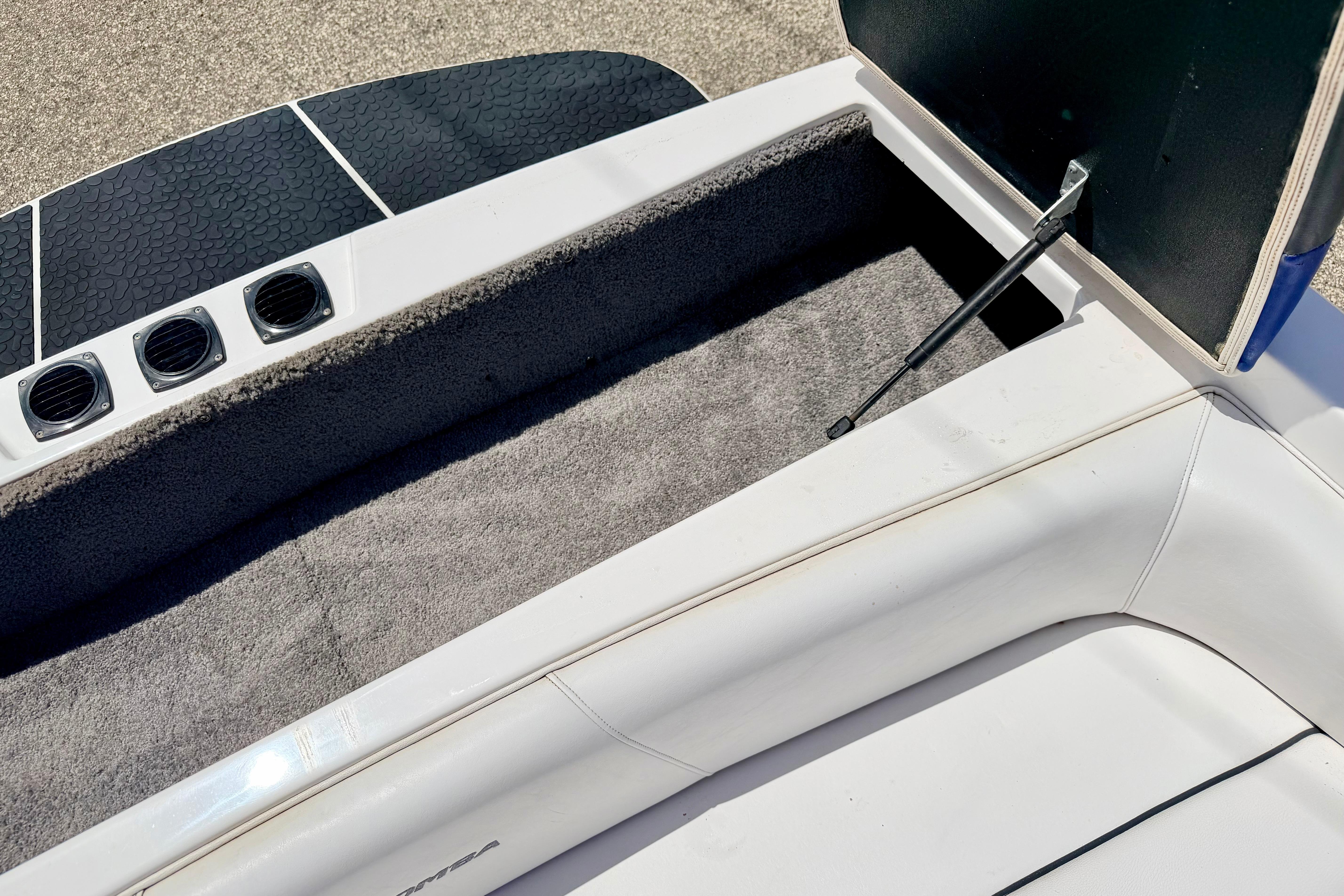2008 Moomba Outback V boat interior storage compartment with open lid and carpeted lining.