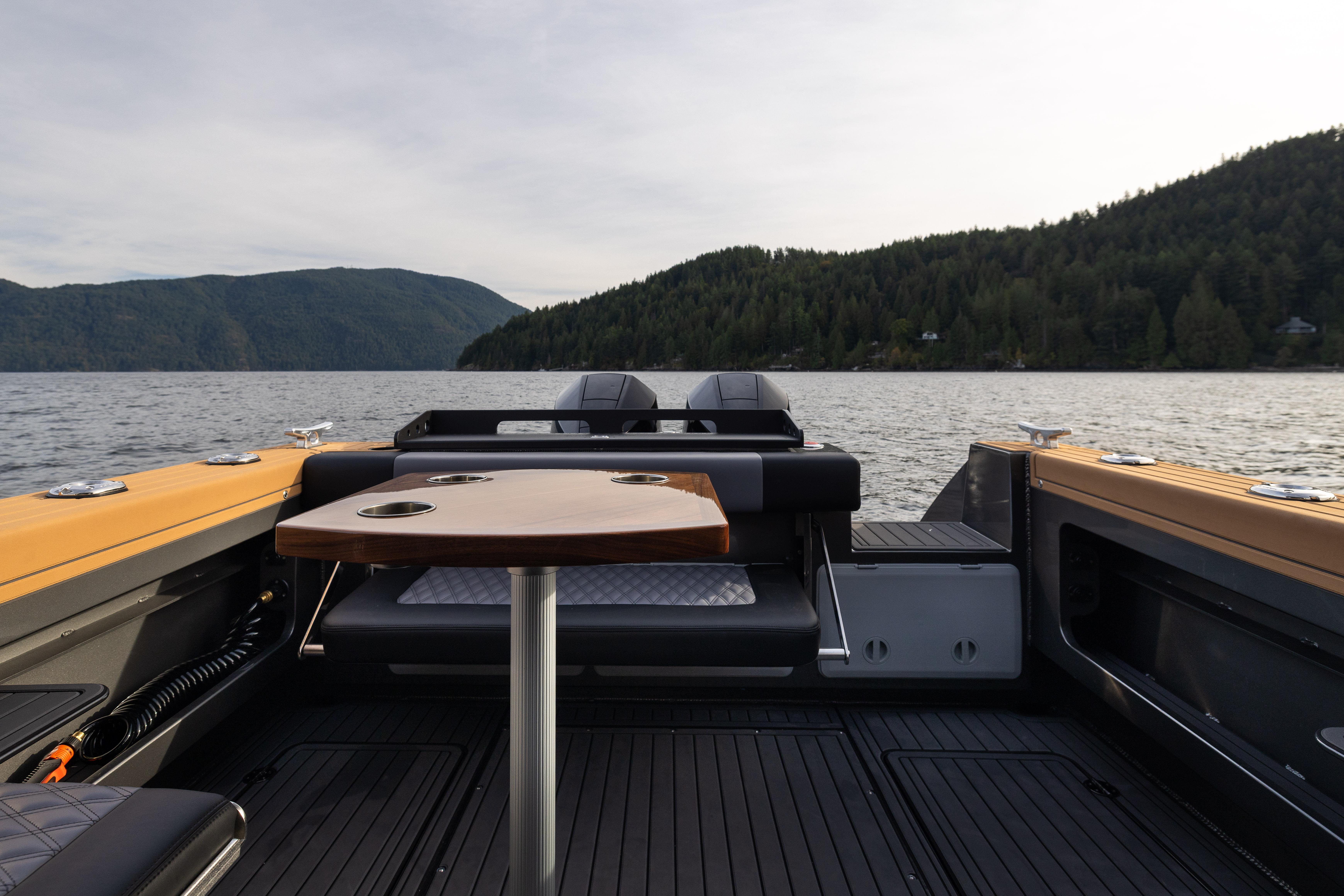 2026 Jasper Marine Defender 22 boat interior with scenic lake and forest backdrop.