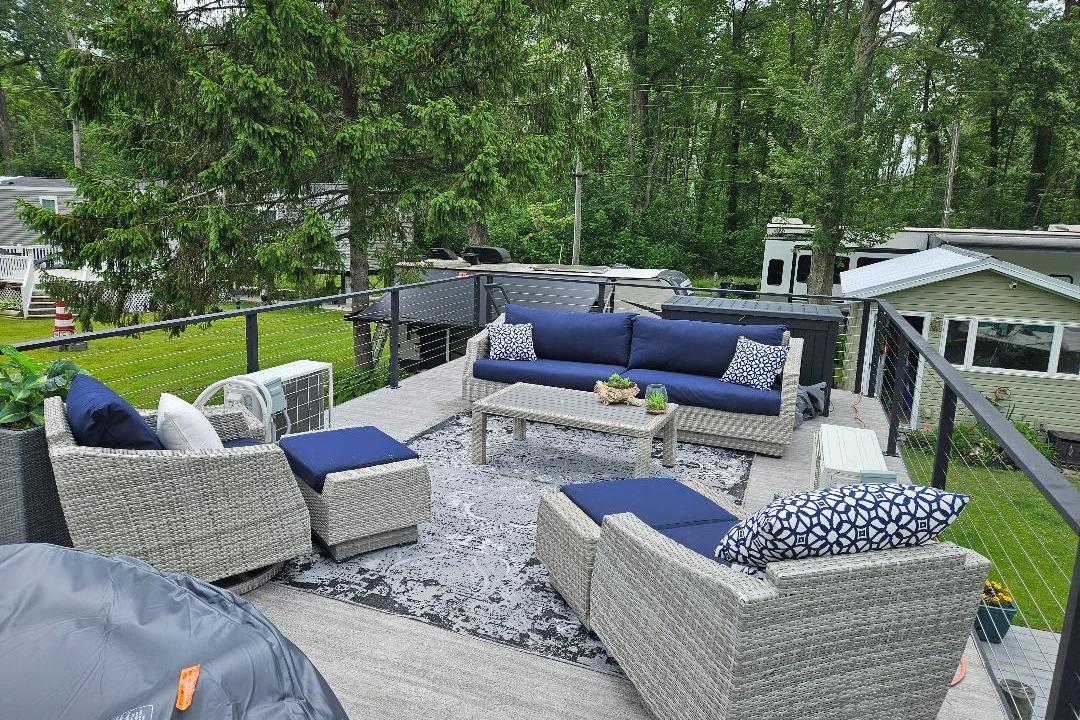 Rooftop deck on 2021 East Coast Houseboats Freedom 40 with outdoor seating and lush surroundings.
