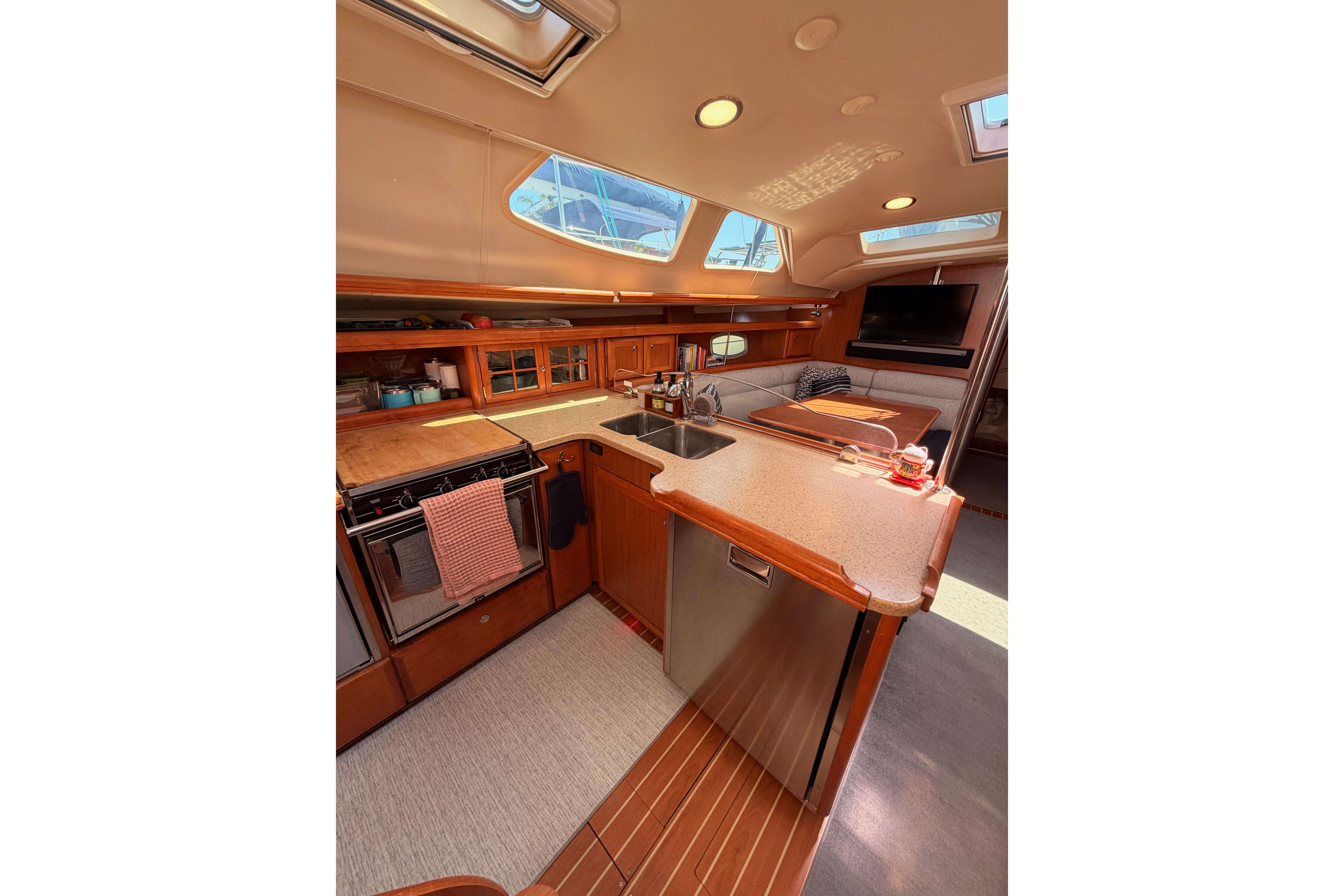 Luxurious interior of 2008 Hunter 45 Deck Salon yacht with modern kitchen amenities.