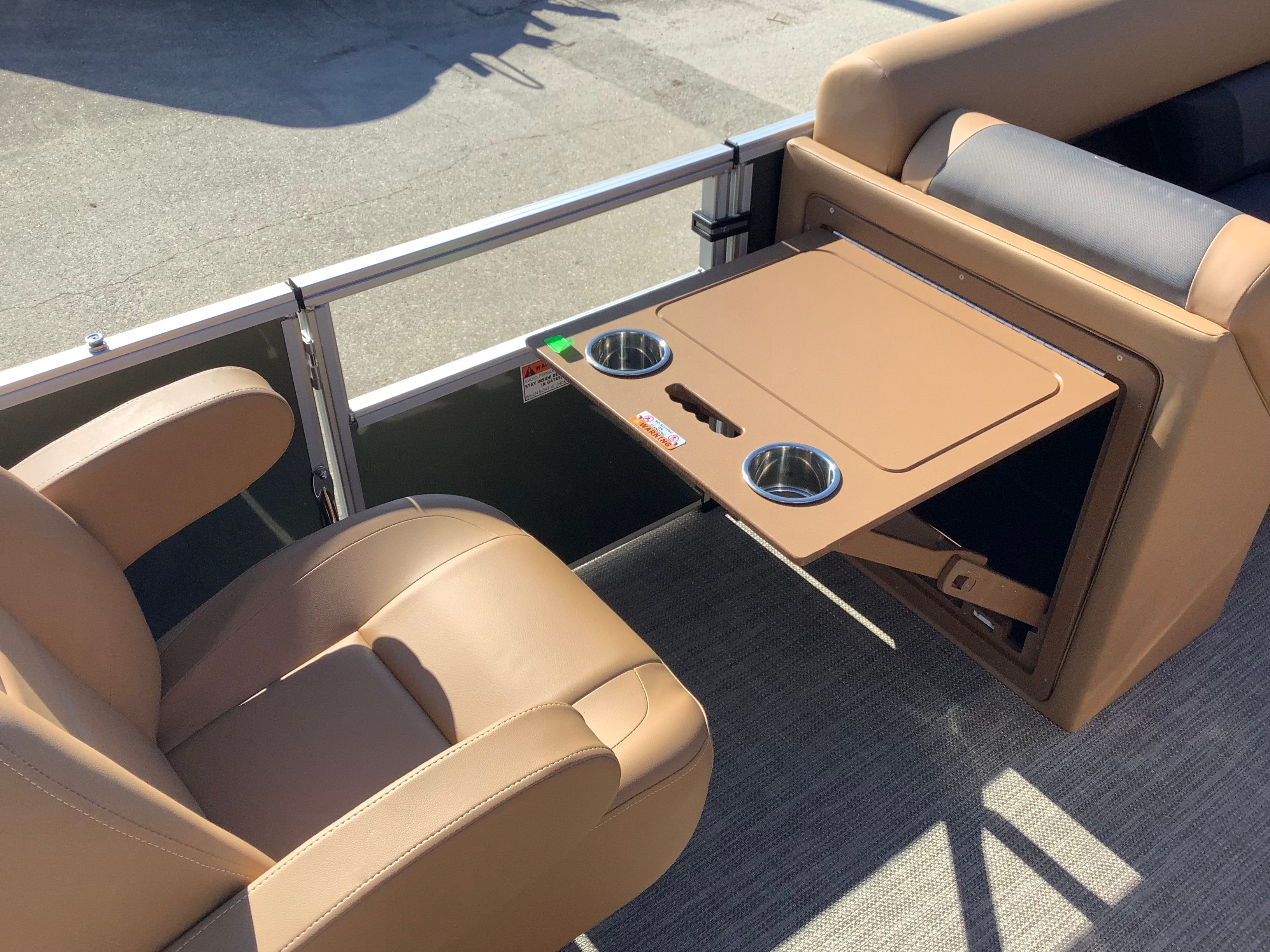 Interior of 2026 Landau 21 Island Breeze with foldable table and cup holders.