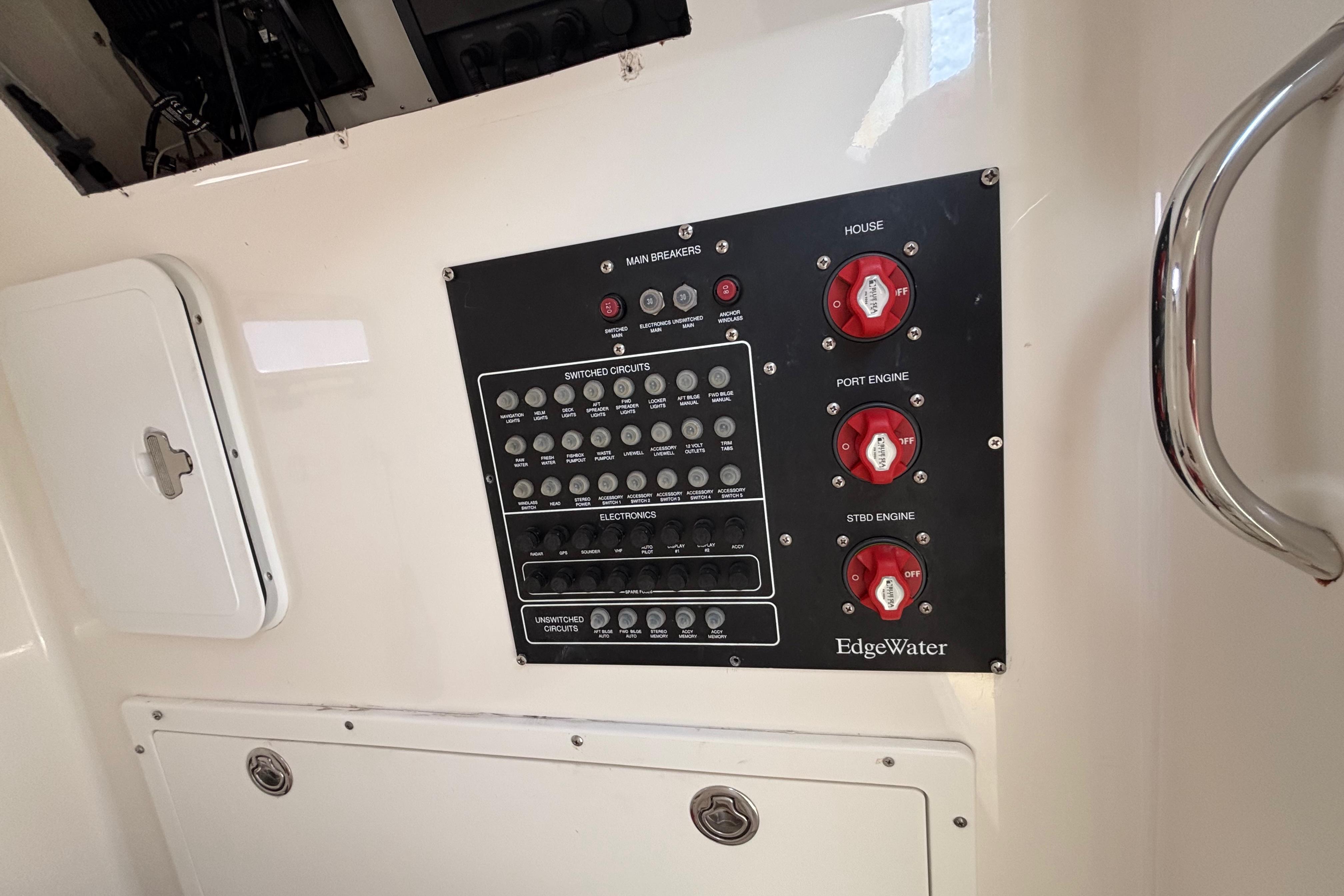 Control panel of a 2006 Edgewater 318CC boat with switches and circuit breakers.