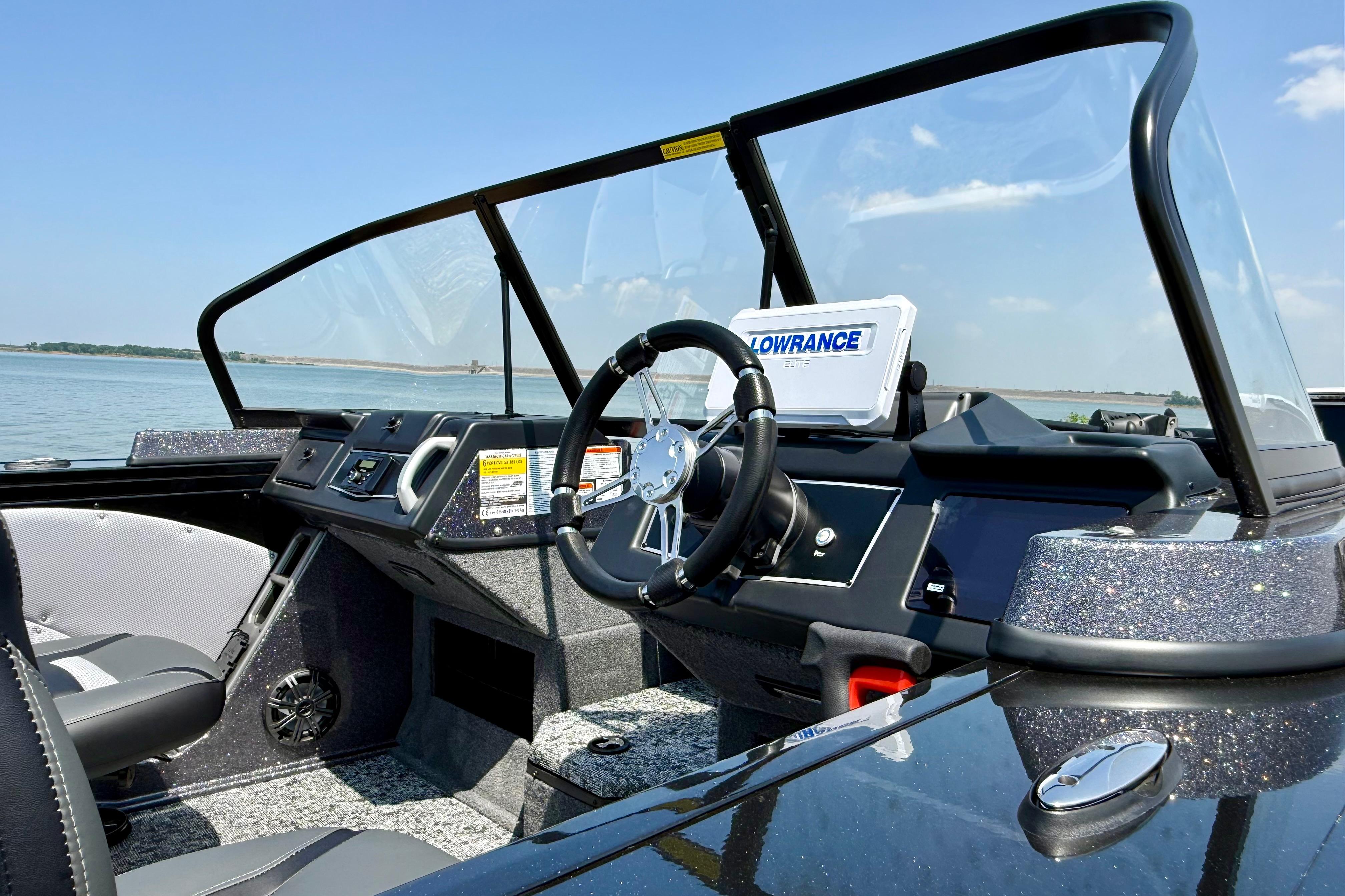 2026 Ranger VX1788 WT boat cockpit with steering wheel and Lowrance display on a sunny day.