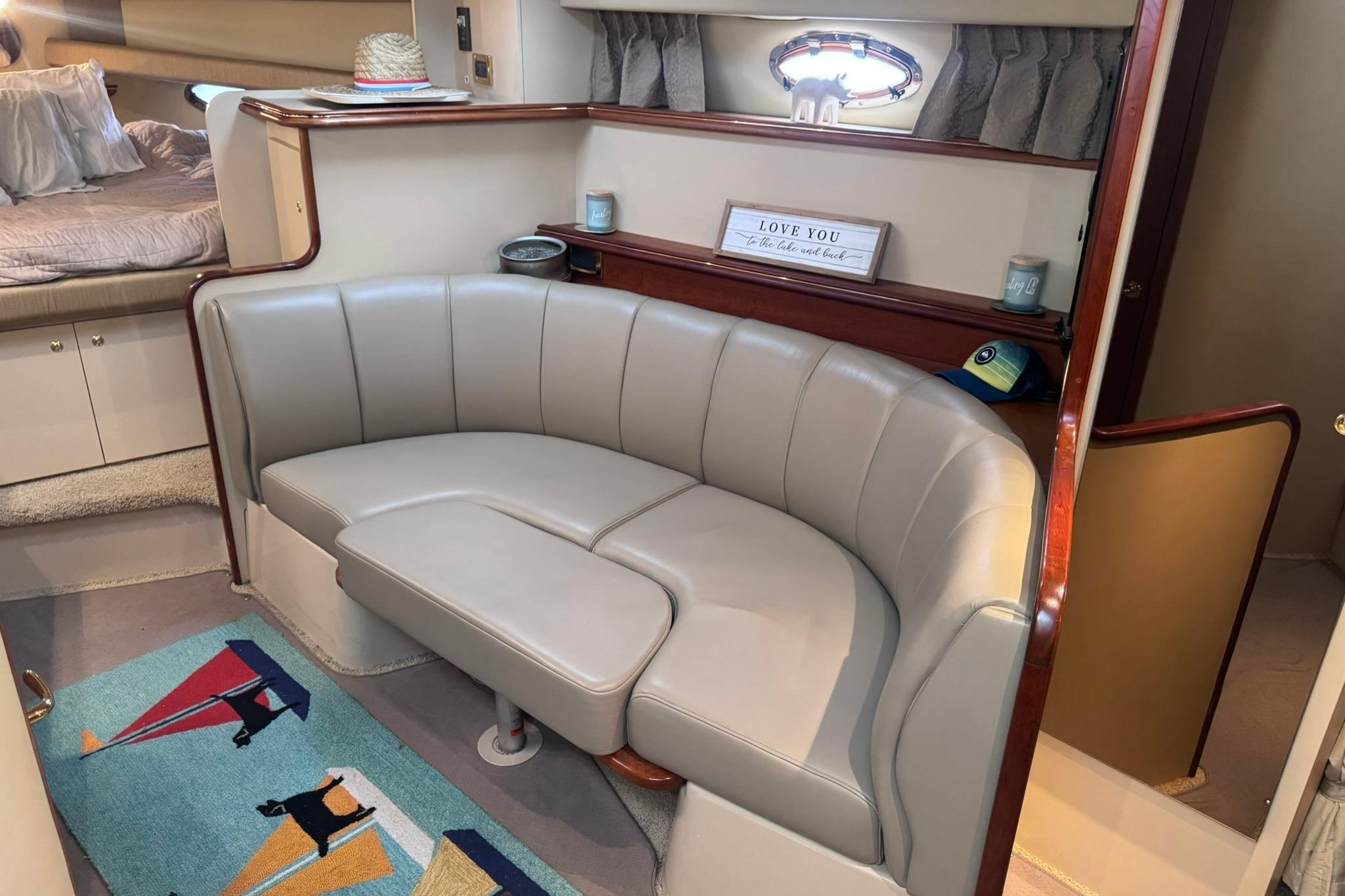 Interior of 2002 Cruisers Yachts 3275 Express with beige seating and nautical decor.