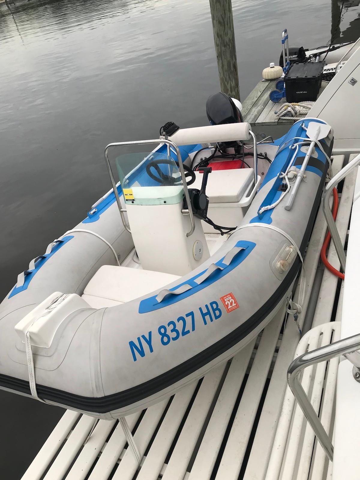 Inflatable boat docked beside a Birchwood 62 Cockpit Motor Yacht, 1989 model.