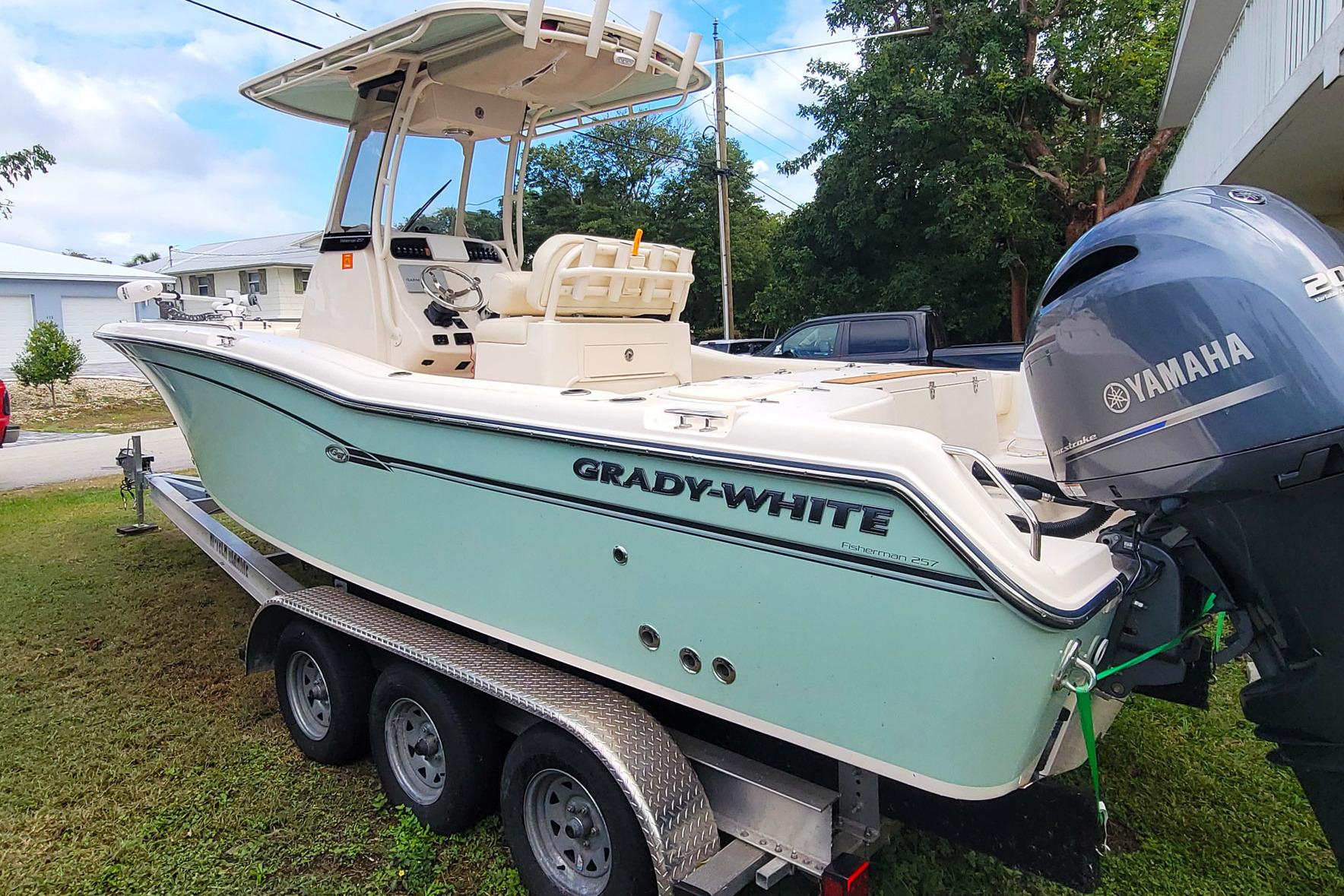 2019 Grady-White Fisherman 257 boat on trailer with Yamaha engine, parked outdoors.