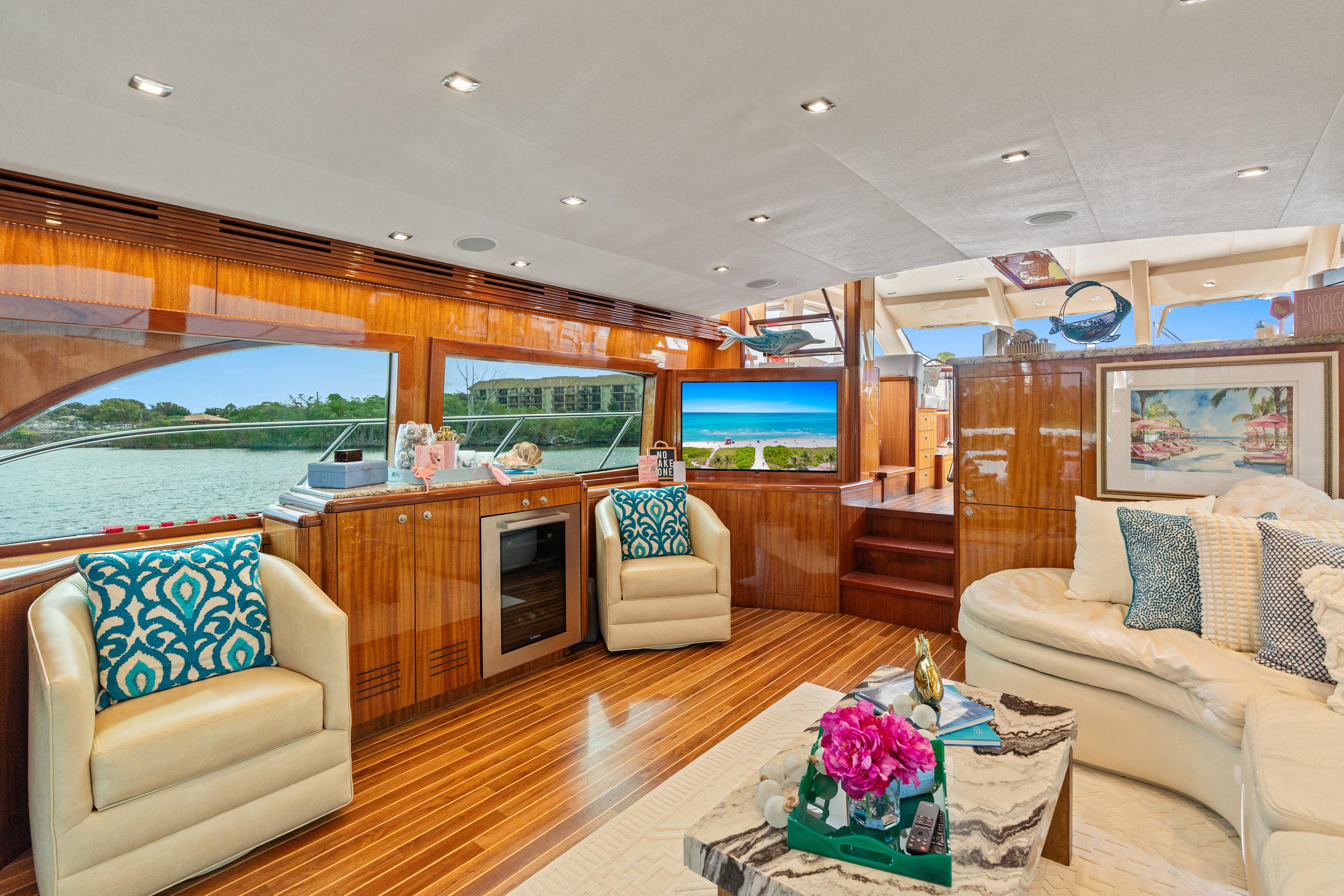 Luxurious interior of a 2008 Hatteras 64 Motor Yacht with elegant seating and scenic views.