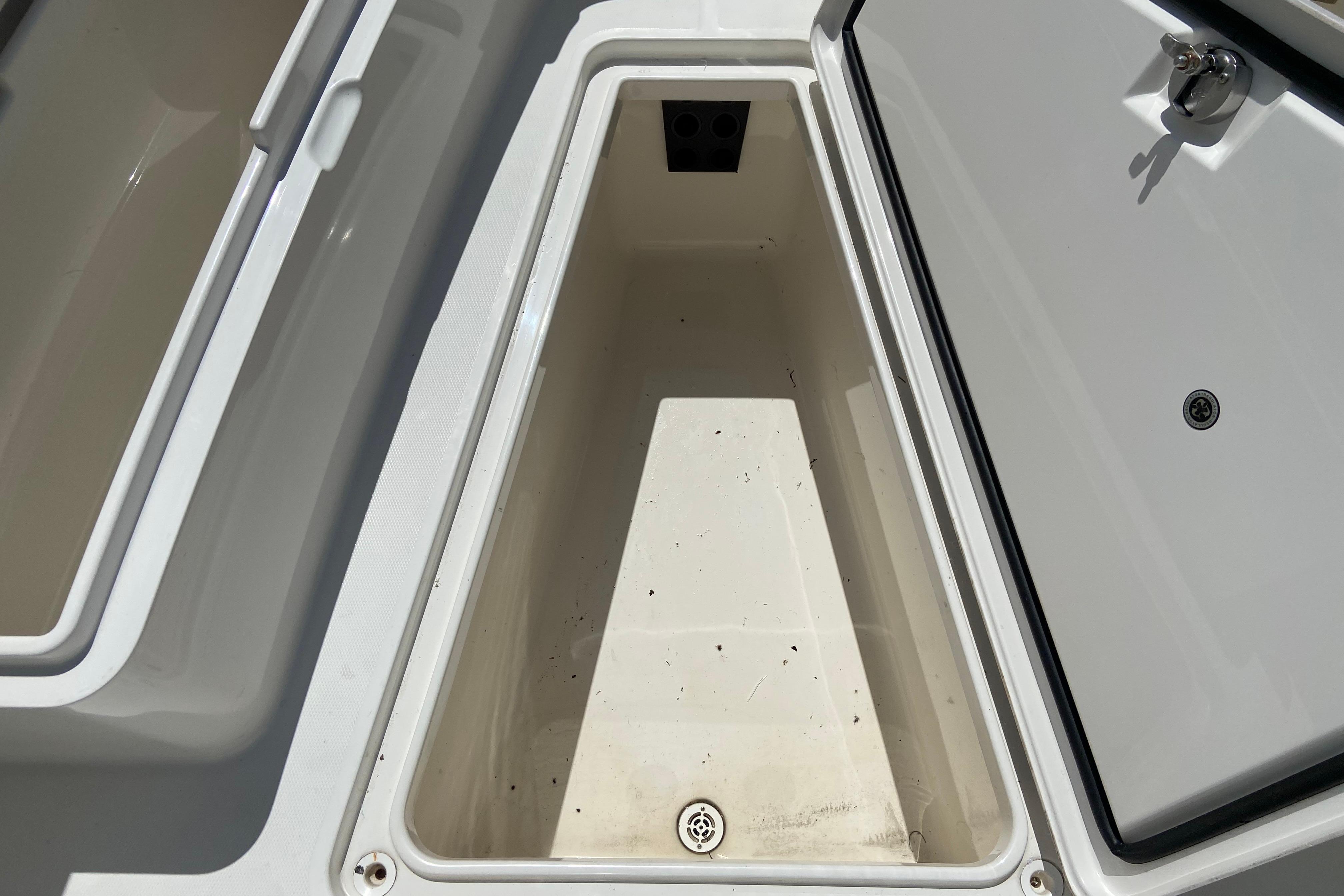 Open storage compartment on a 2021 Regulator 28 boat, showcasing interior space.