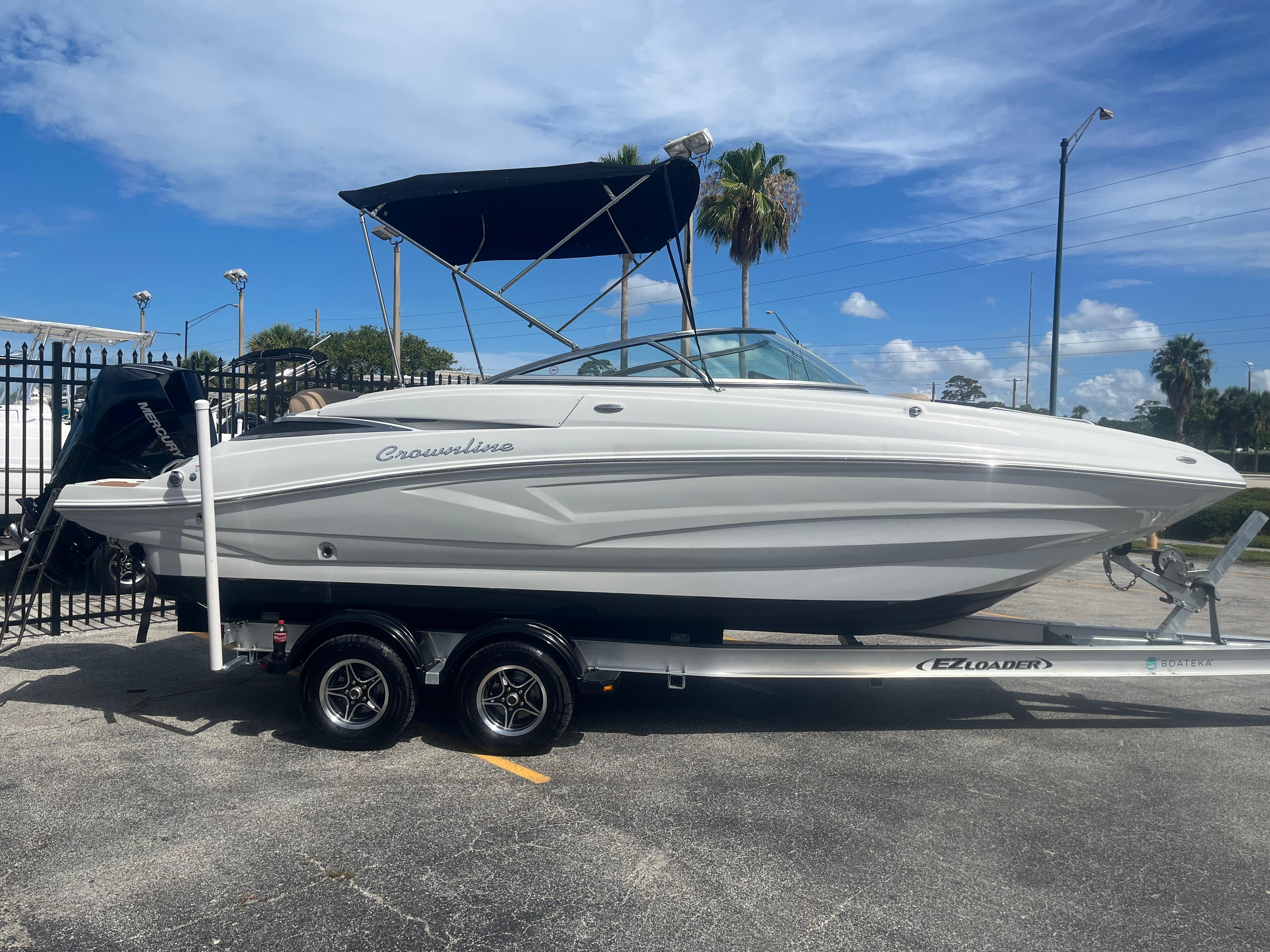 2022 Crownline Eclipse E235 XS boat on trailer, parked outdoors under blue sky.
