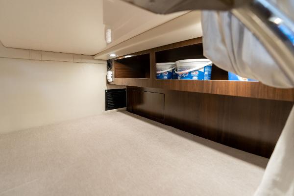 Interior cabin storage of 2016 Regal 28 Express boat with shelves and lighting.