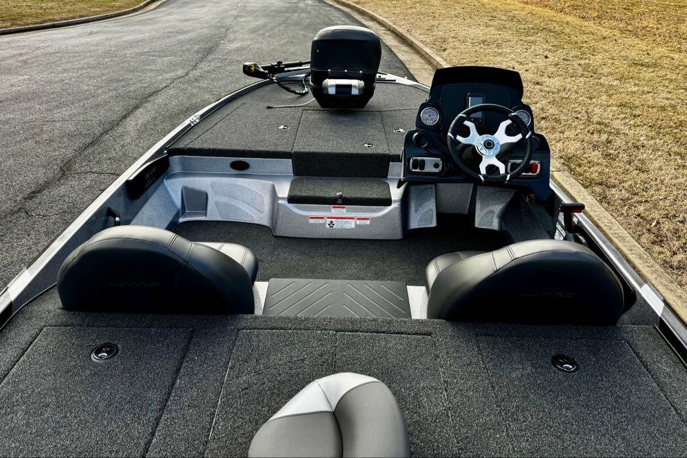 2026 Nitro Z17 boat interior with steering wheel and seating on a paved road.