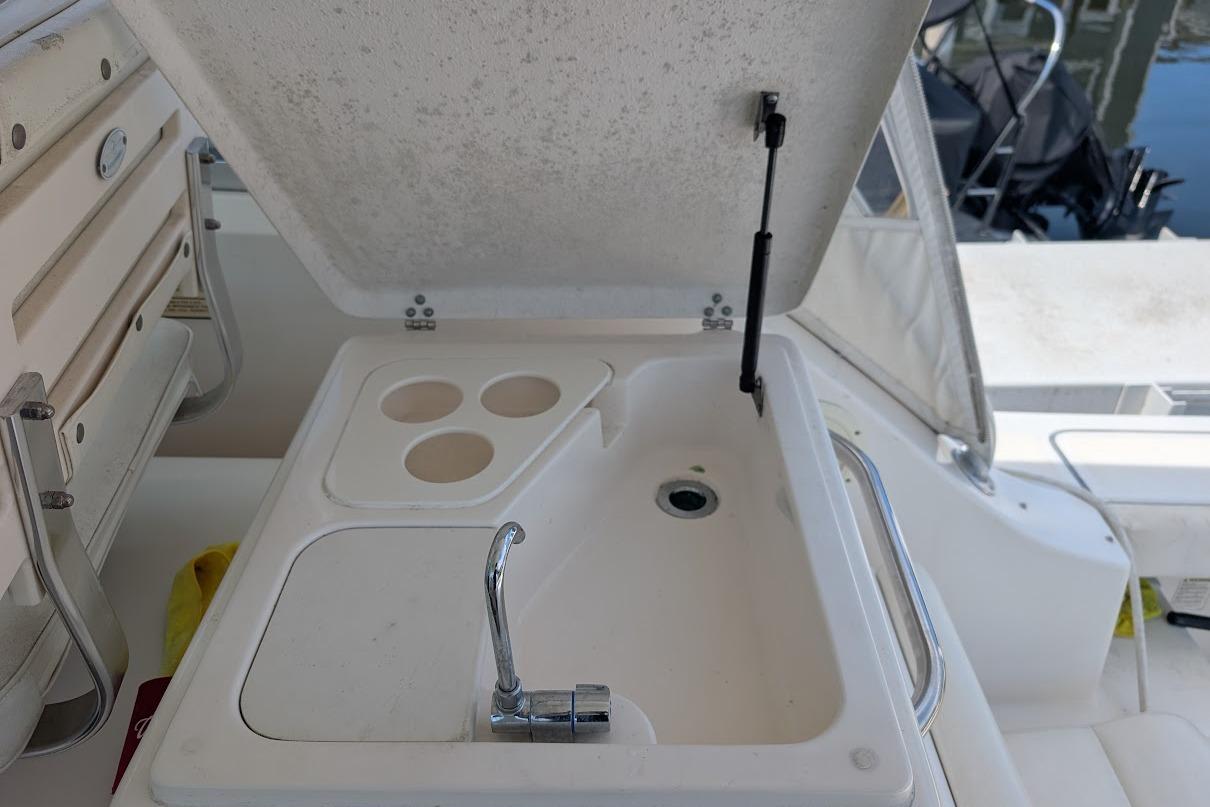 Boat sink and cup holders on a 2000 Pursuit 3400 Express yacht.