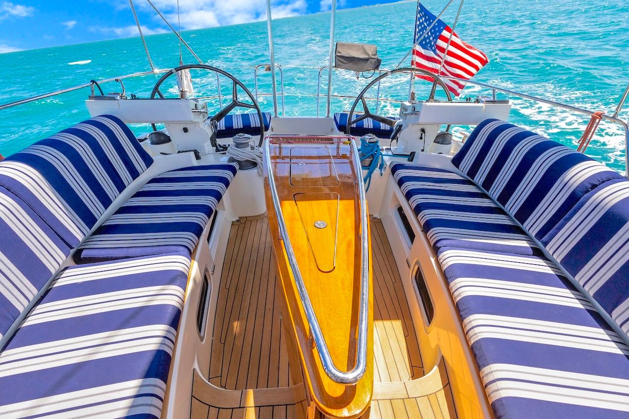 Luxurious 2011 Southerly 57 RS yacht deck with striped seating and ocean view.