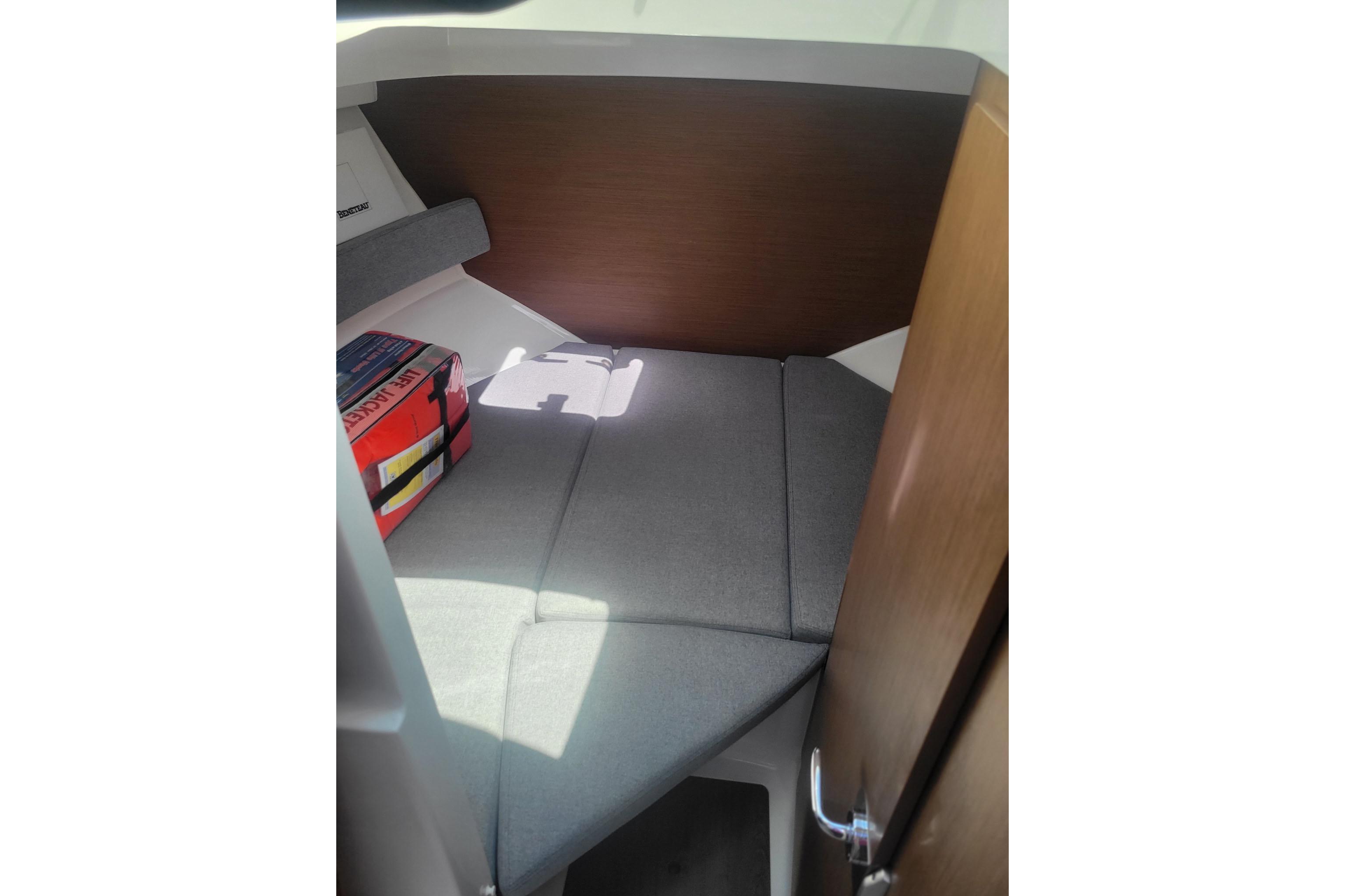 Interior cabin of 2019 Beneteau Antares 23 with cushioned seating and life jacket.