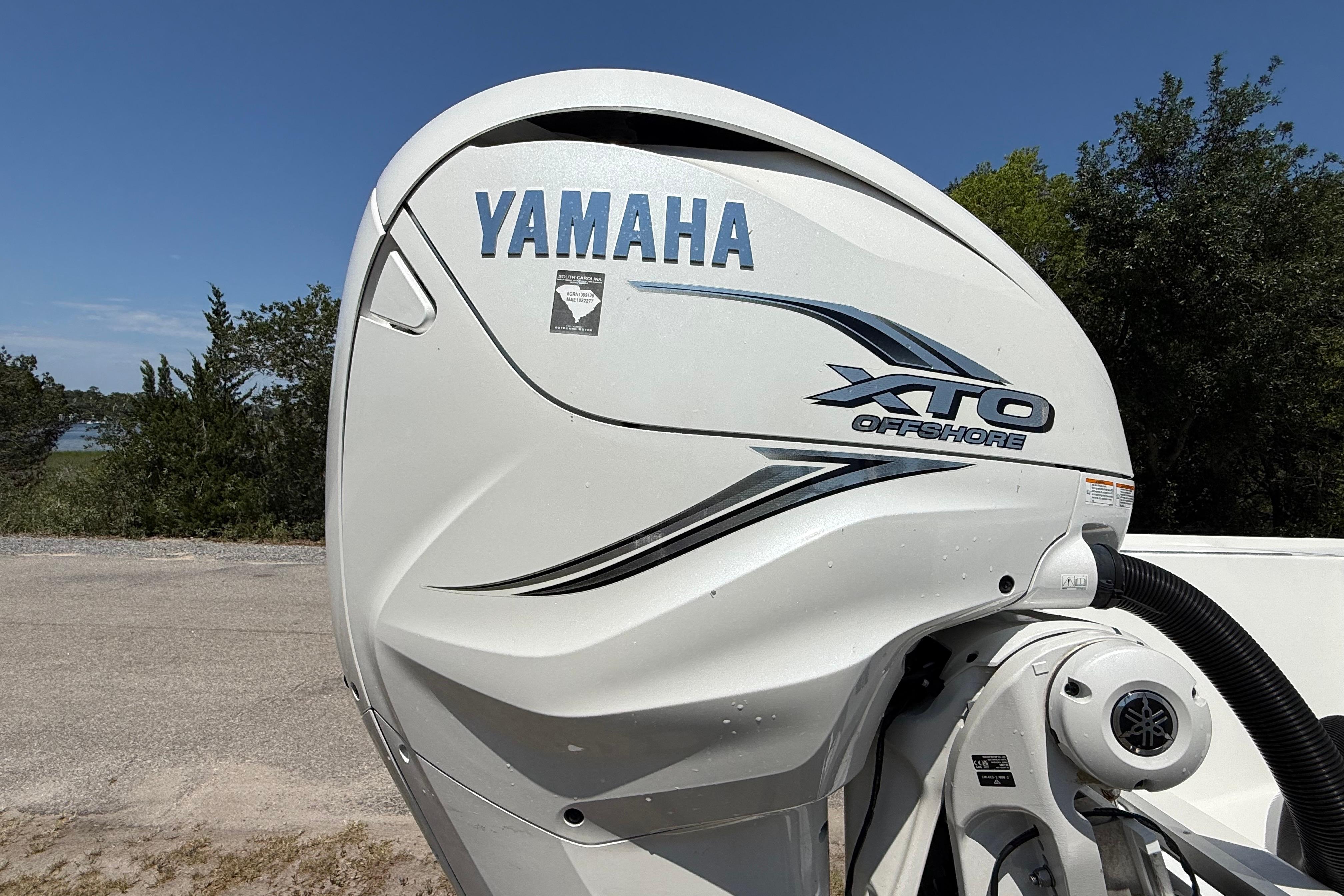 Yamaha XTO Offshore engine on 2023 Regulator 26XO boat, parked outdoors.