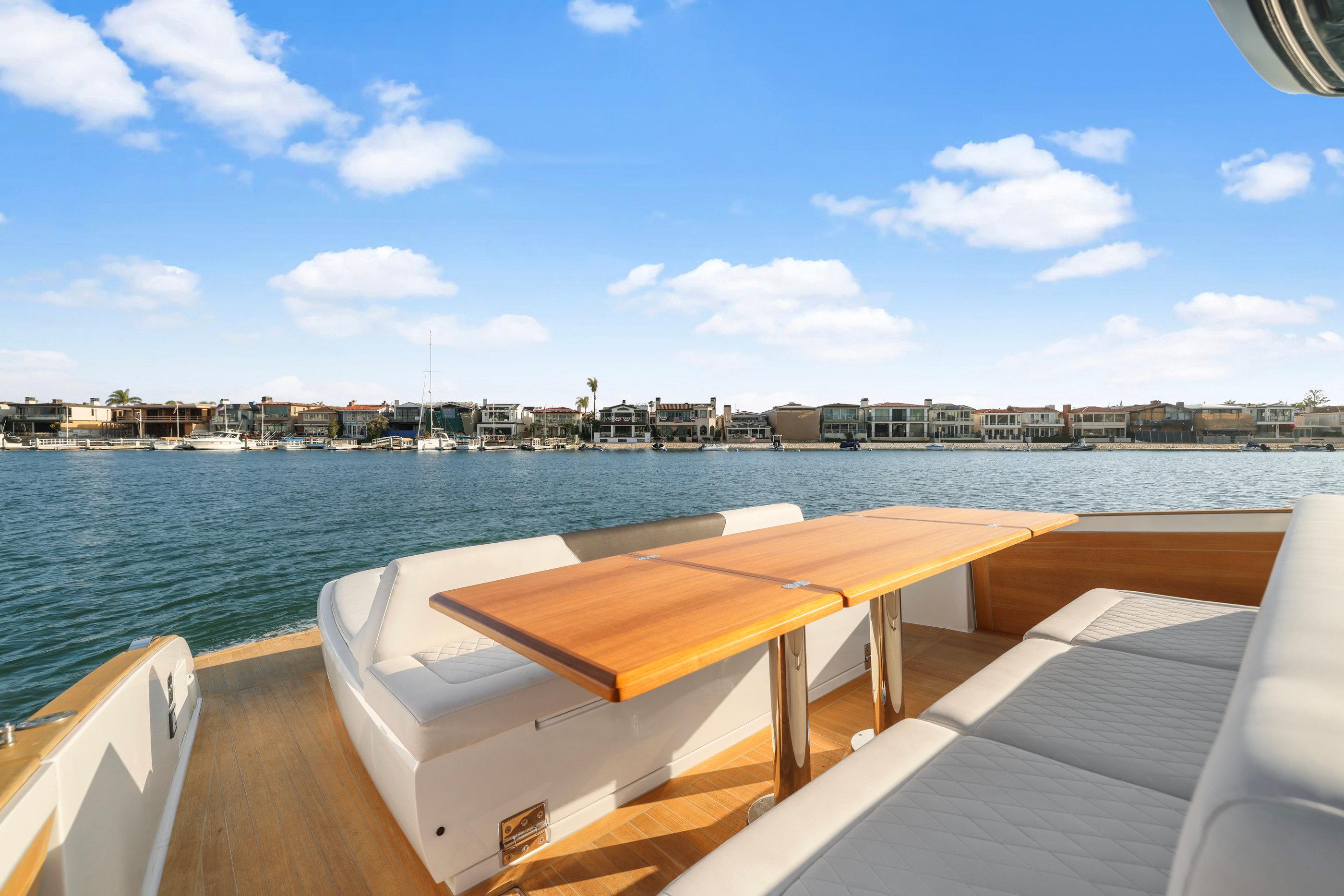 Luxurious 2022 Solaris Power yacht with spacious deck and scenic waterfront view.