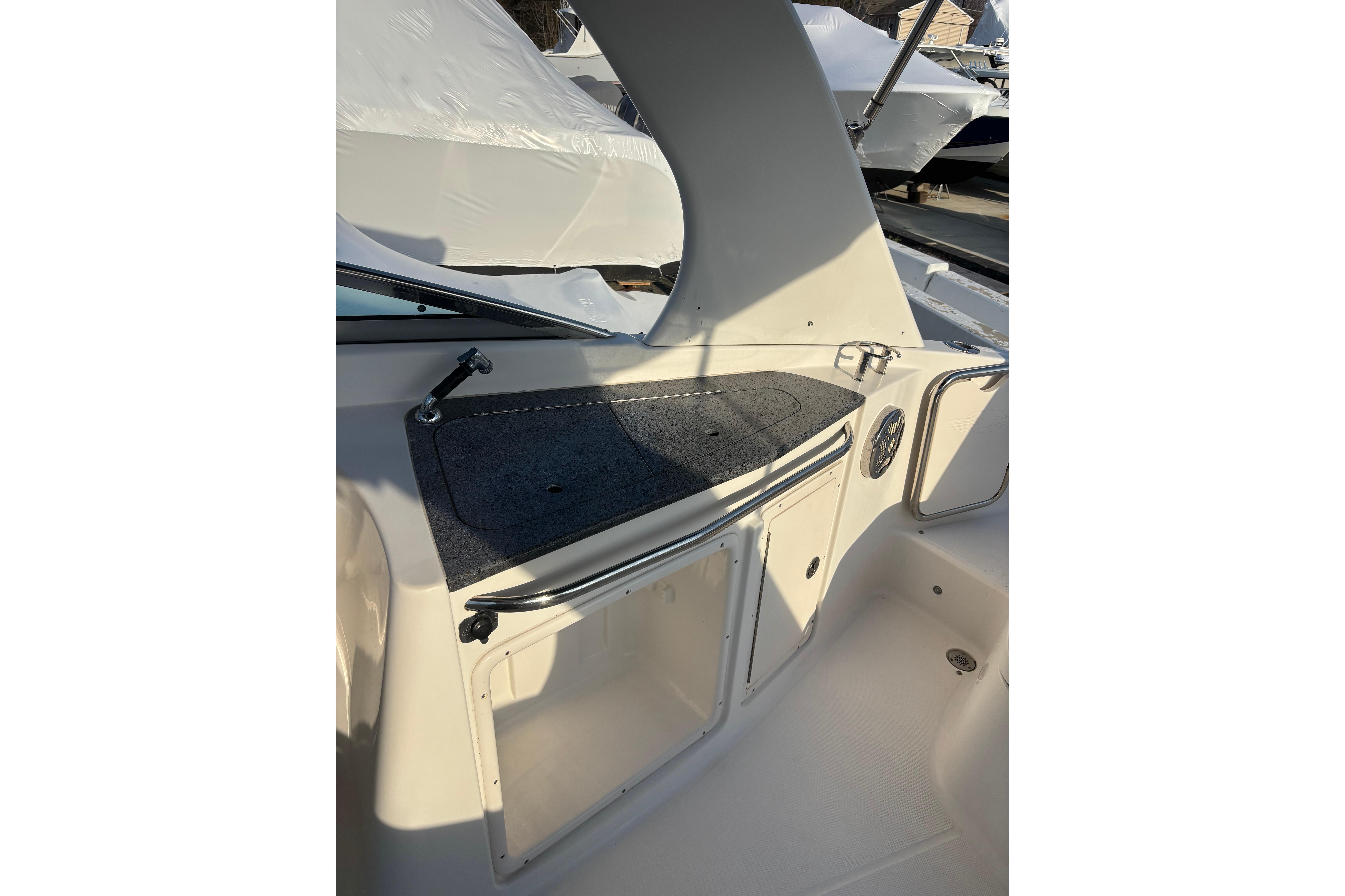 2012 Chaparral 267 SSX boat interior with storage compartment and speaker.