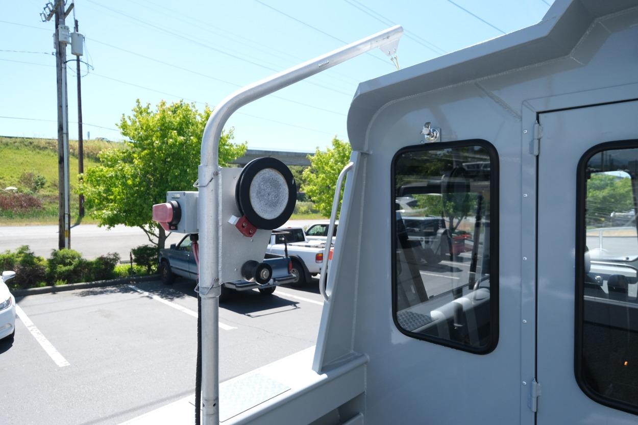 2018 Hewescraft 220 Ocean Pro ET Hardtop boat detail in parking lot setting.