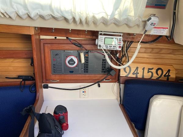 Interior of a 1989 Catalina 30 sailboat with navigation equipment and seating area.