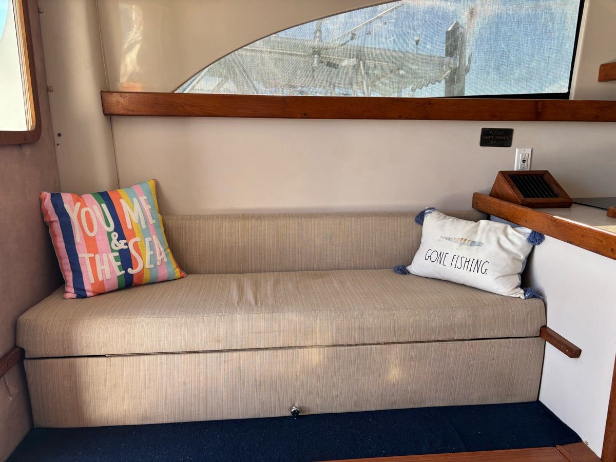 Interior of 1994 Luhrs Convertible with cozy sofa and pillows.