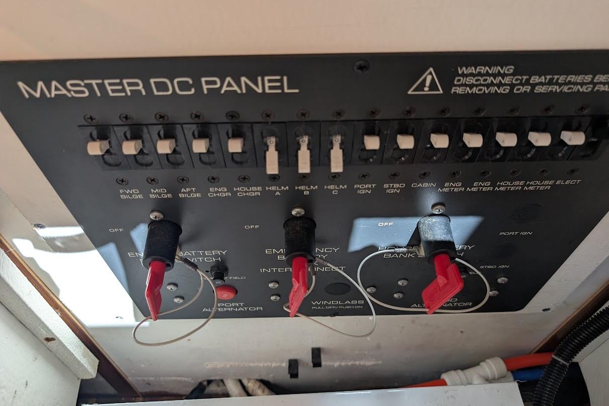 Master DC panel of a 2000 Pursuit 3400 Express boat with switches and warning label.