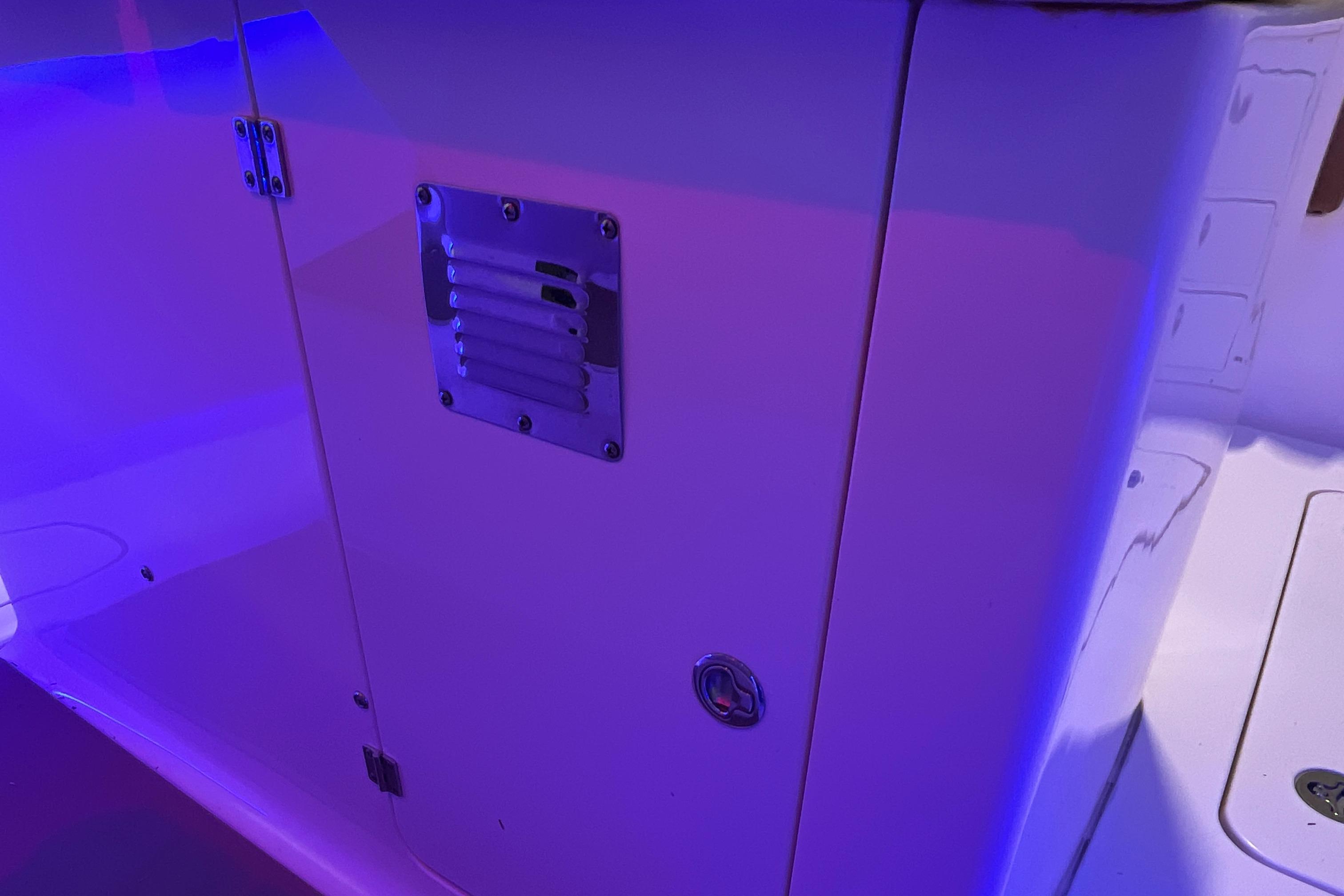 2021 Scout 305 LXF boat interior with blue ambient lighting.