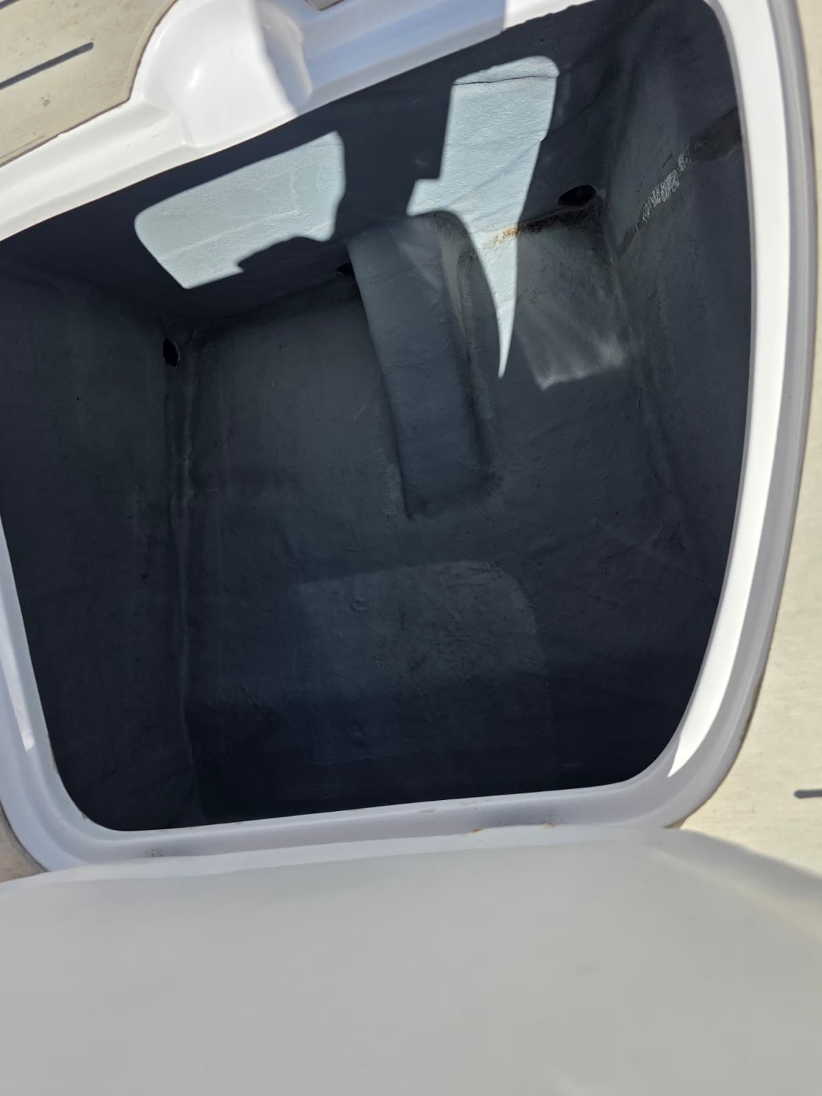 Interior view of an empty storage compartment on a boat.