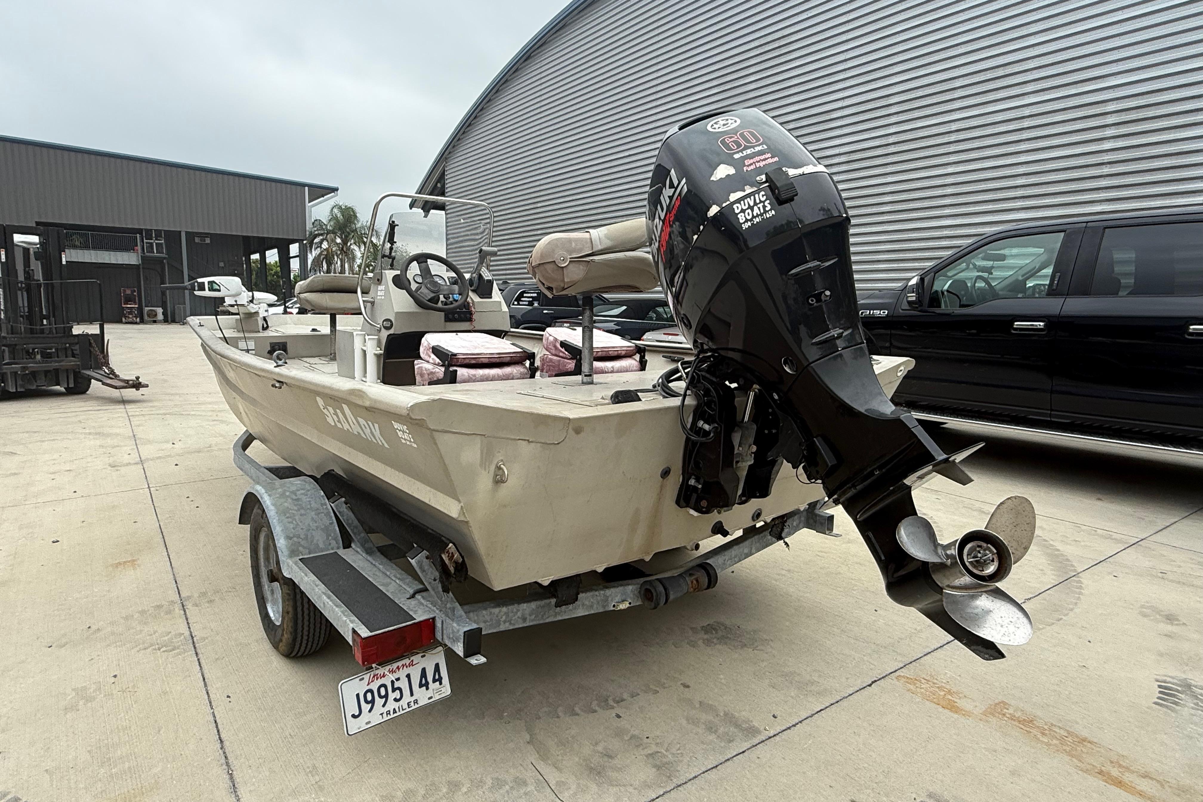 2008 SeaArk 1652 MV boat on trailer with Suzuki outboard motor.