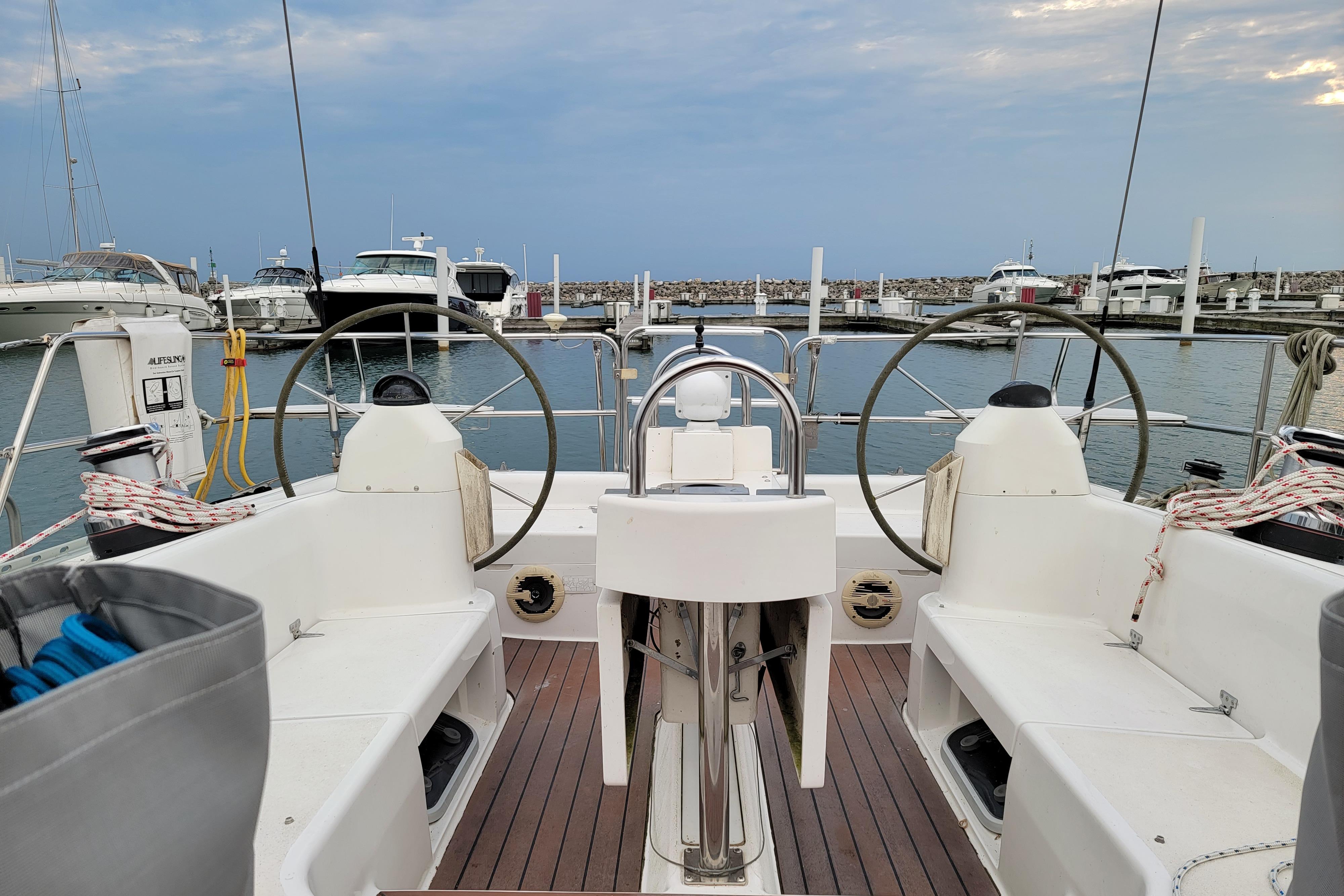 Cockpit view of a 1999 Catalina 400 sailboat docked in a marina.