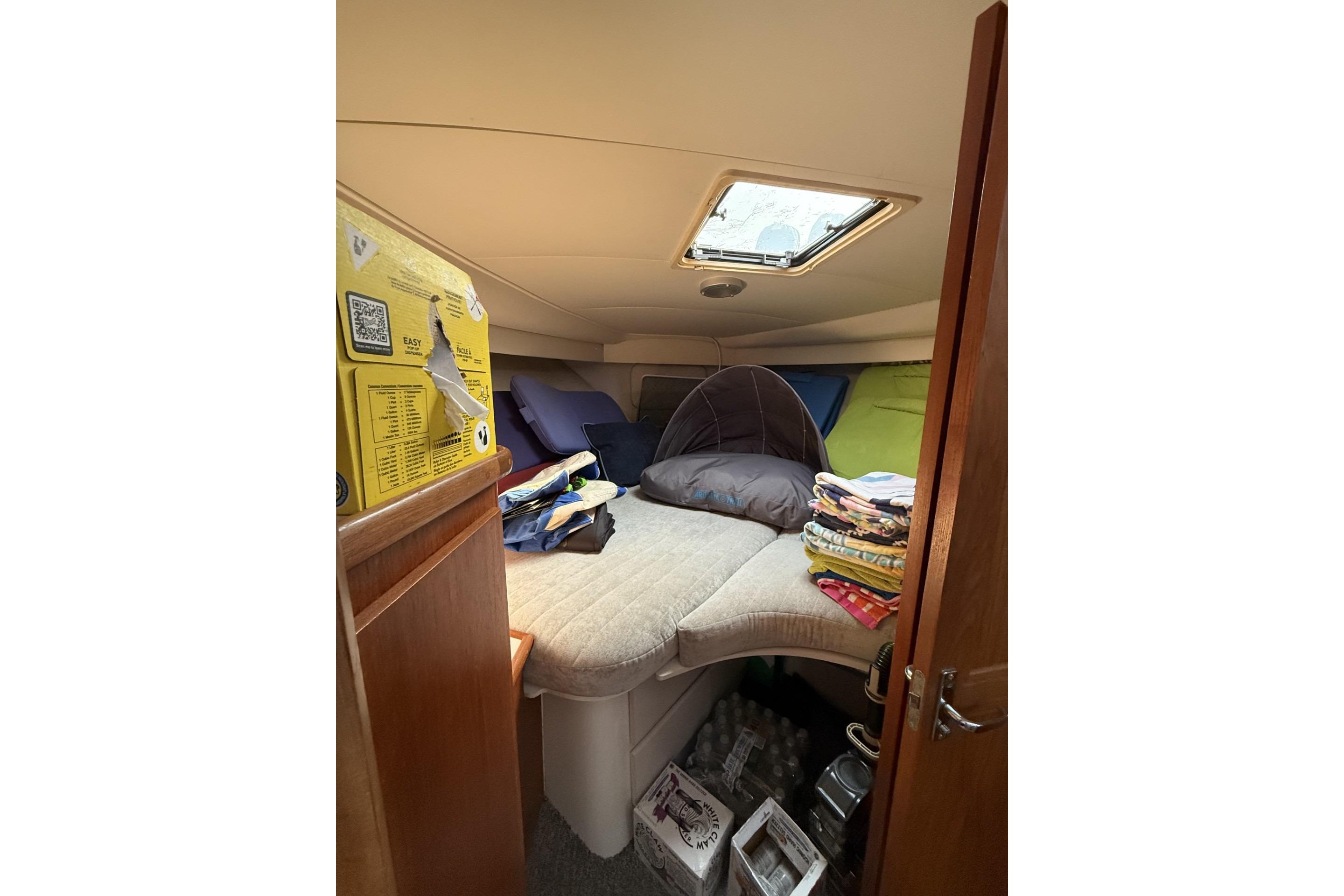 Interior cabin of 1993 Carver 350 Motor Yacht with bedding and storage.