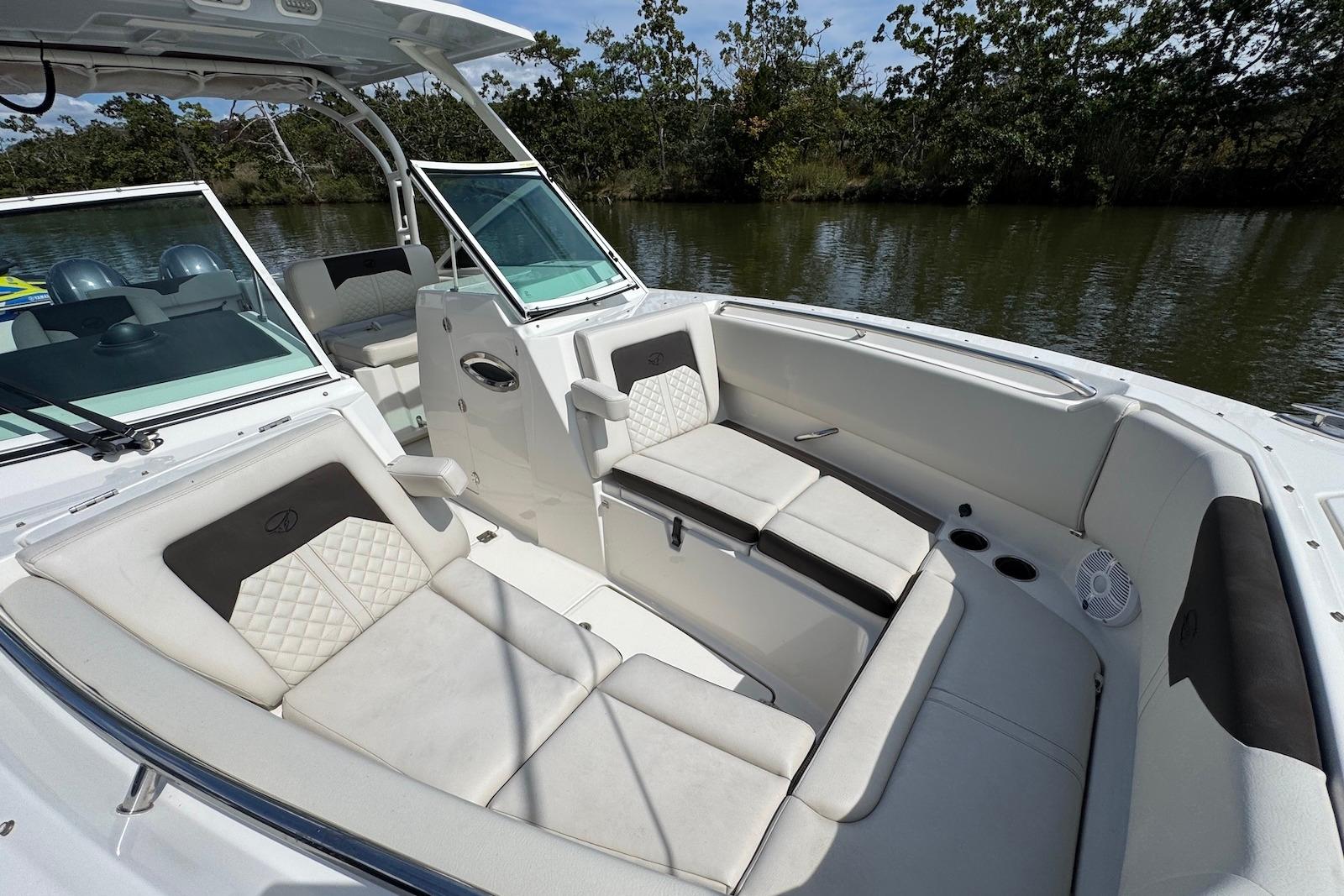 Luxurious interior of 2022 Sailfish 276 DC boat with comfortable seating and scenic water view.