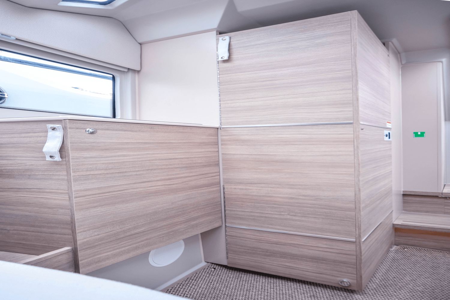 Interior of the Saxdor SX320 GTO with wood paneling and a window.