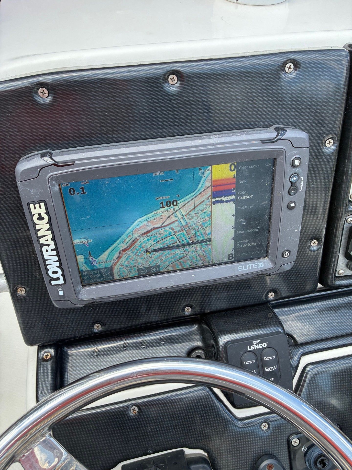 A navigation system on a boat displays a map with depth information.